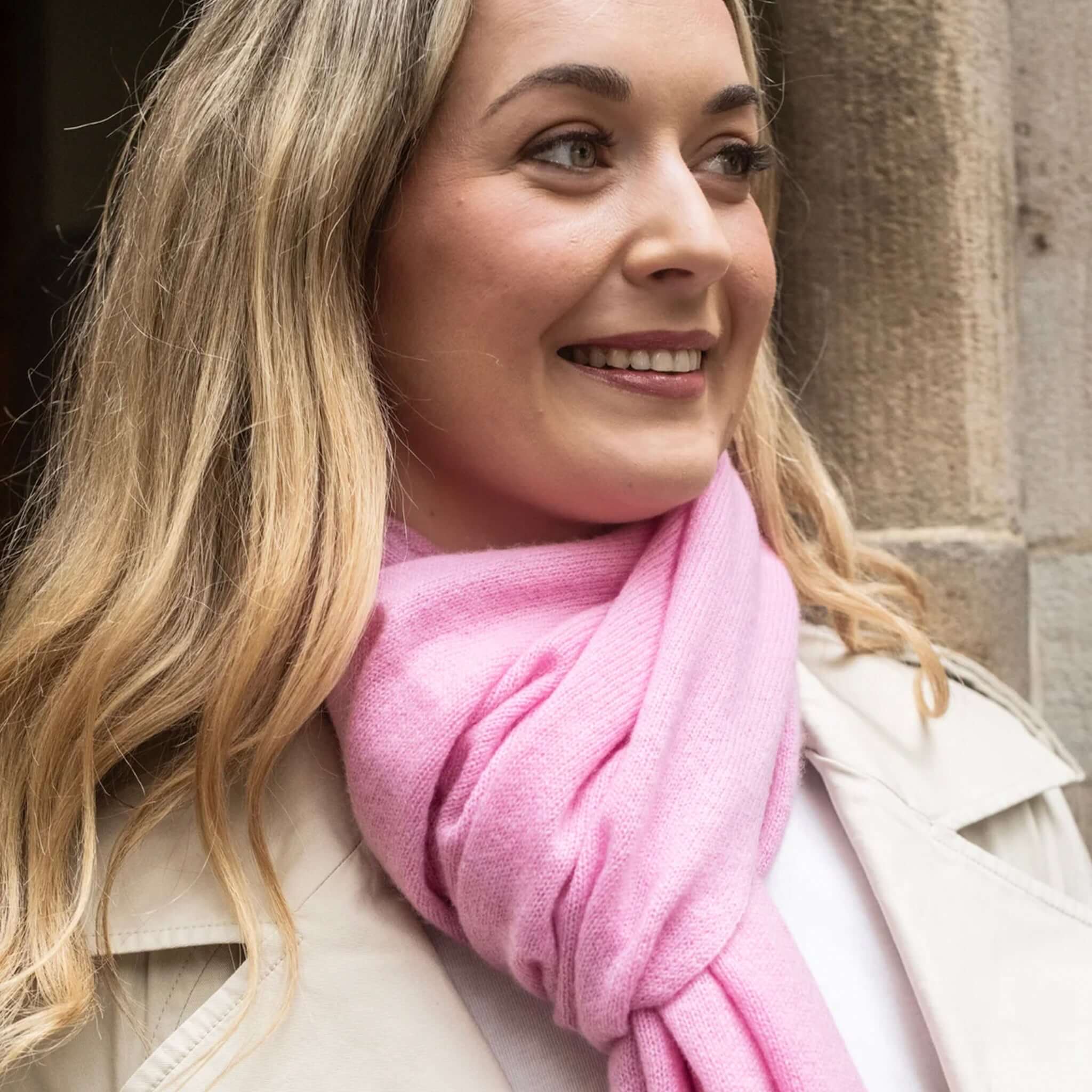 Woman wearing the Esperance & Co Classic Cashmere Topper - Glam Pink wrapped stylishly.