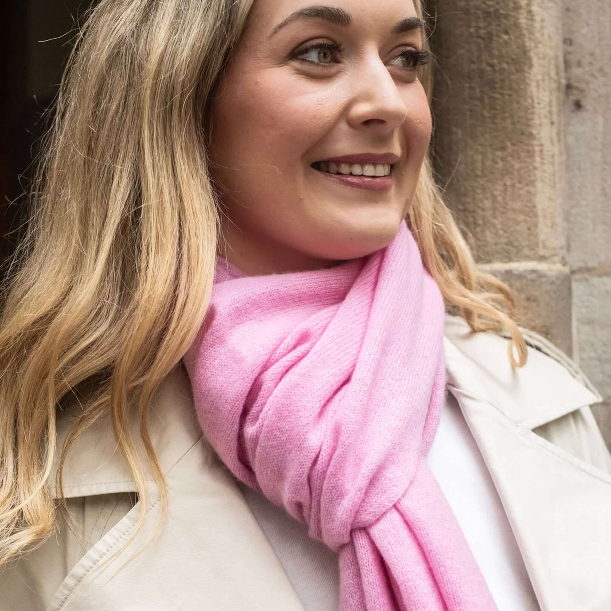Esperance & Co Classic Cashmere Topper - Glam Pink draped stylishly around a woman's neck, enhancing her casual outfit.