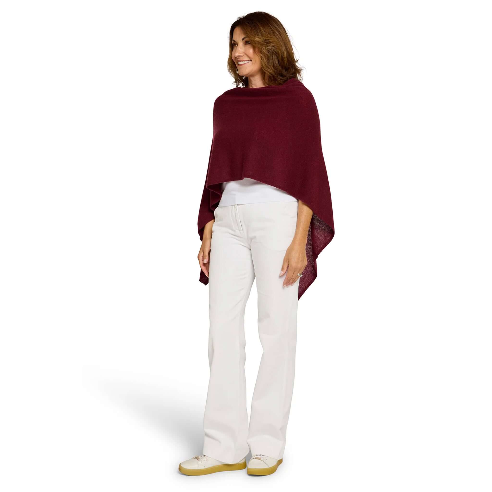 Woman wearing Esperance & Co Classic Cashmere Topper - Sangria, styled for casual elegance with white pants.