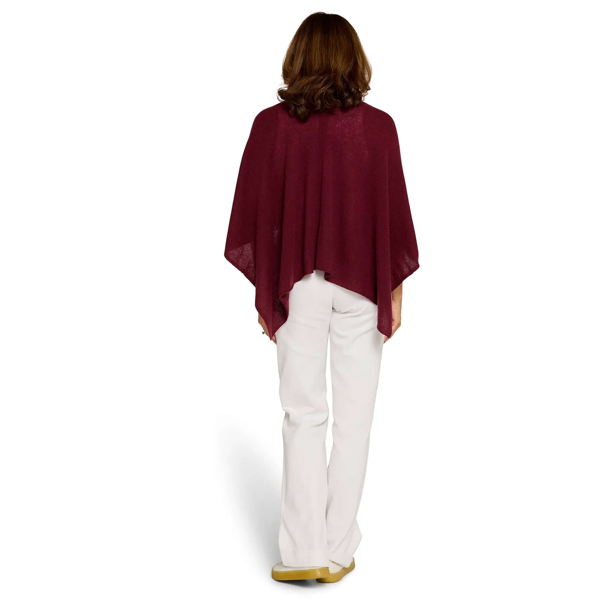 Woman wearing the Esperance & Co Classic Cashmere Topper - Sangria from the back over white pants.