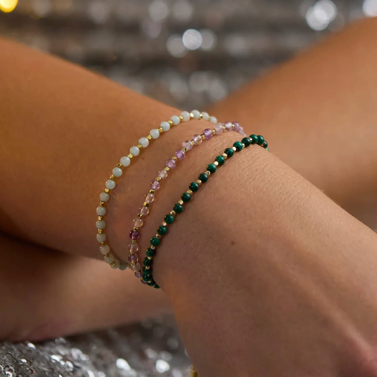 Estella Bartlett Amelia gemstone bracelets stacked on the wrist in several colourways