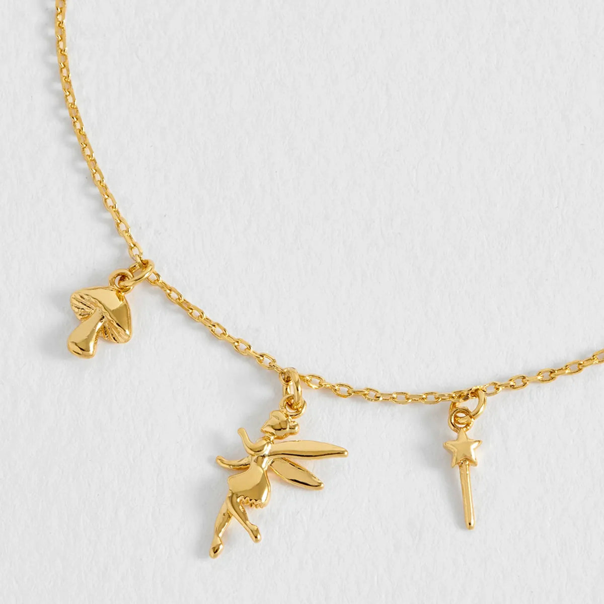 Estella Bartlett Fairy Charm Bracelet close-up of the gold fairy, mushroom and wand charms