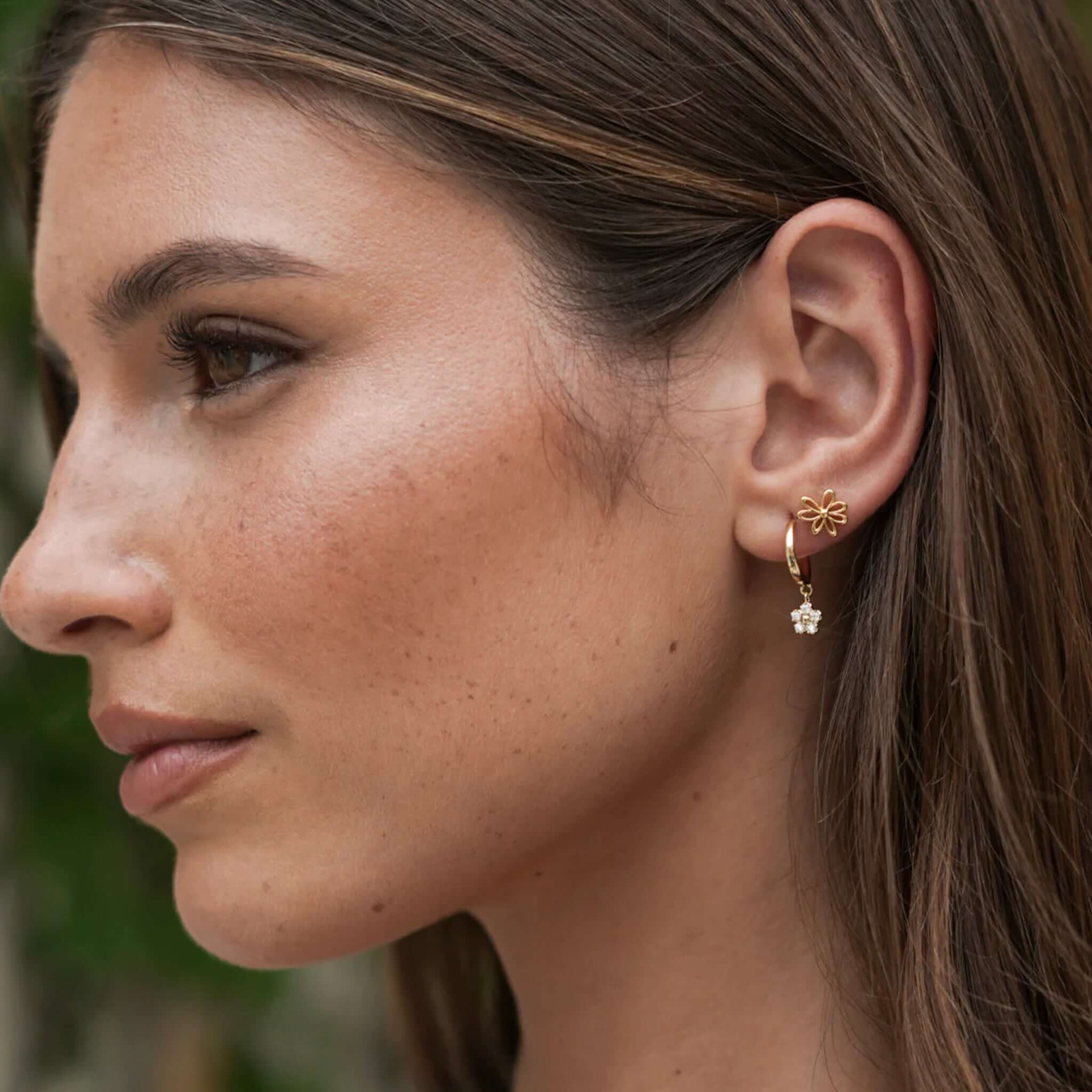 Alt Tag: Estella Bartlett Flower Hoop CZ Earrings - Gold Plated on model, petite gold hoops with sparkling CZ daisy charm