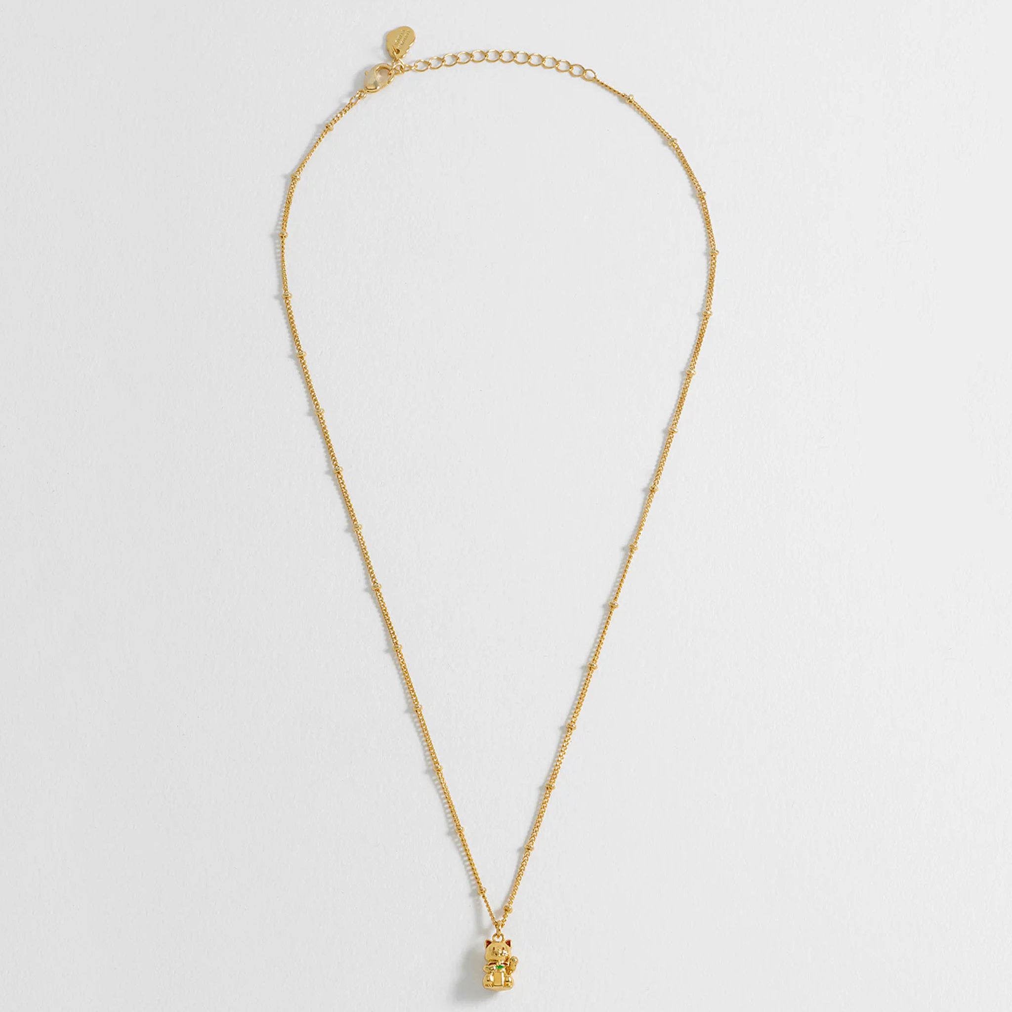 Gold necklace on a light gray background