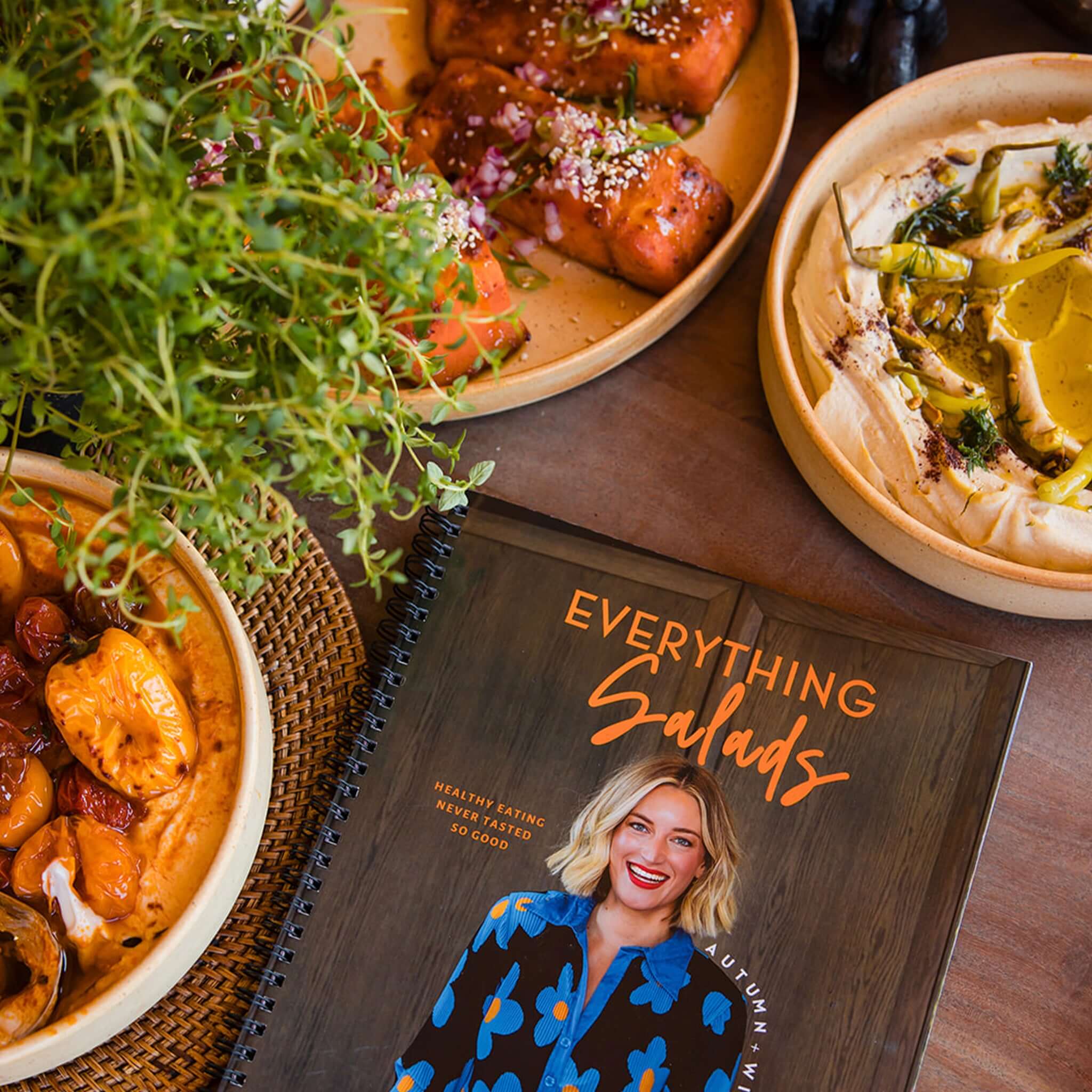 Alt Tag: Everything Salads: Autumn & Winter cookbook cover with spiral binding, author holding salad platter, autumn & winter healthy recipes