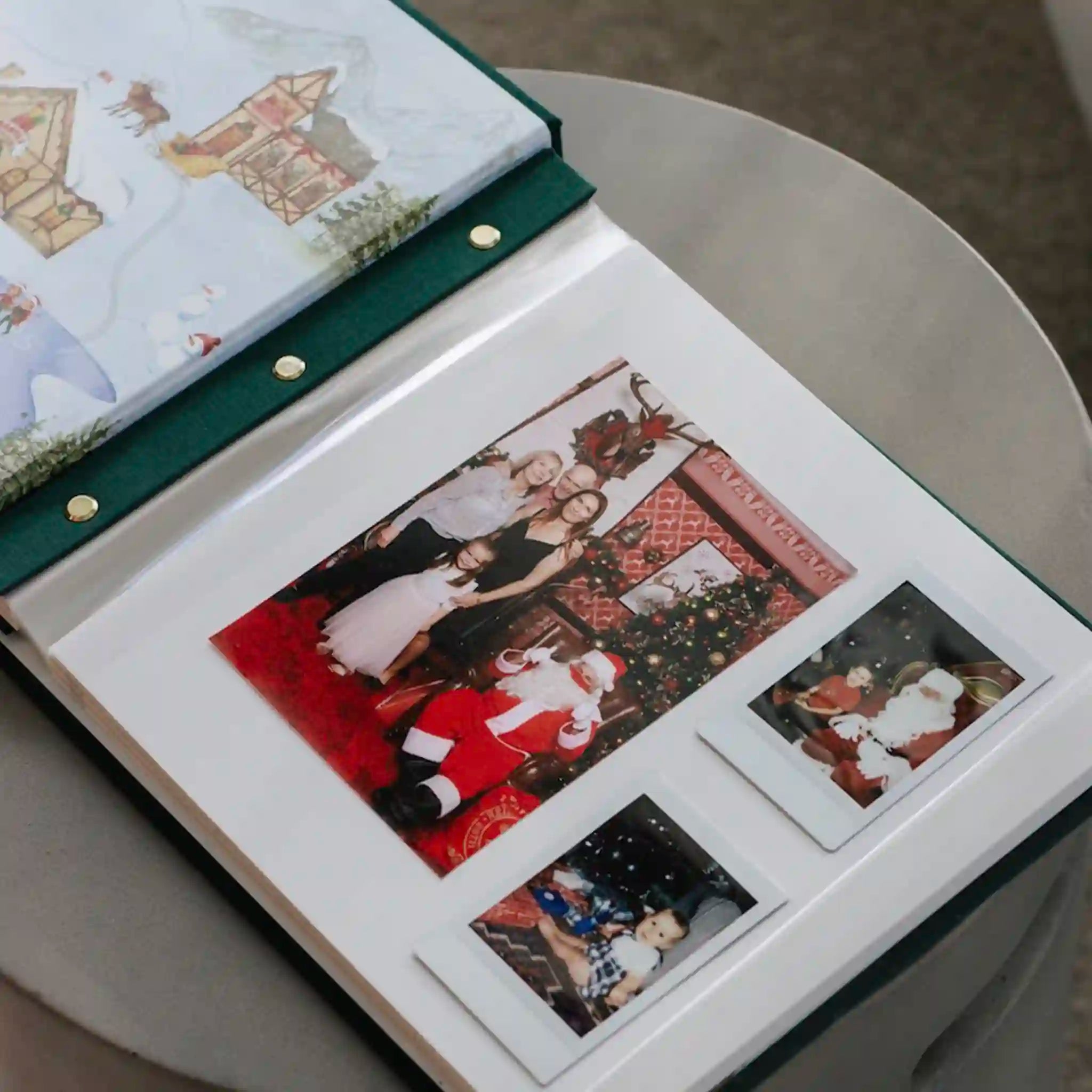 Open photo album with Christmas-themed pictures of a couple and Santa Claus.