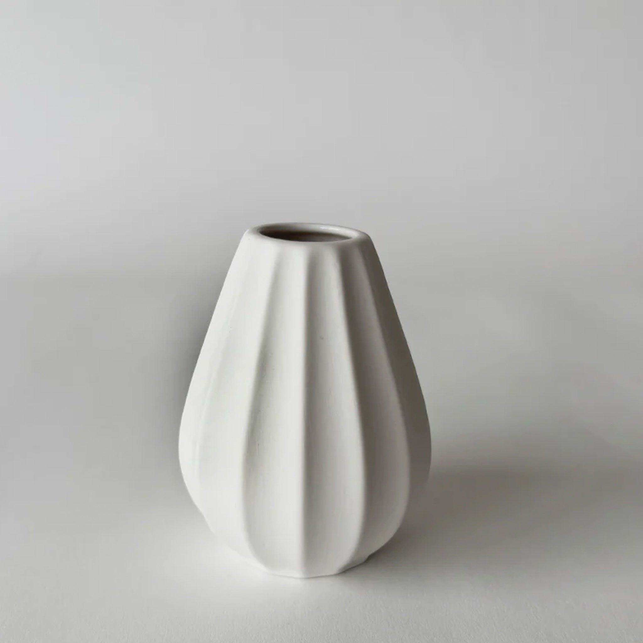 White textured vase on a gray background