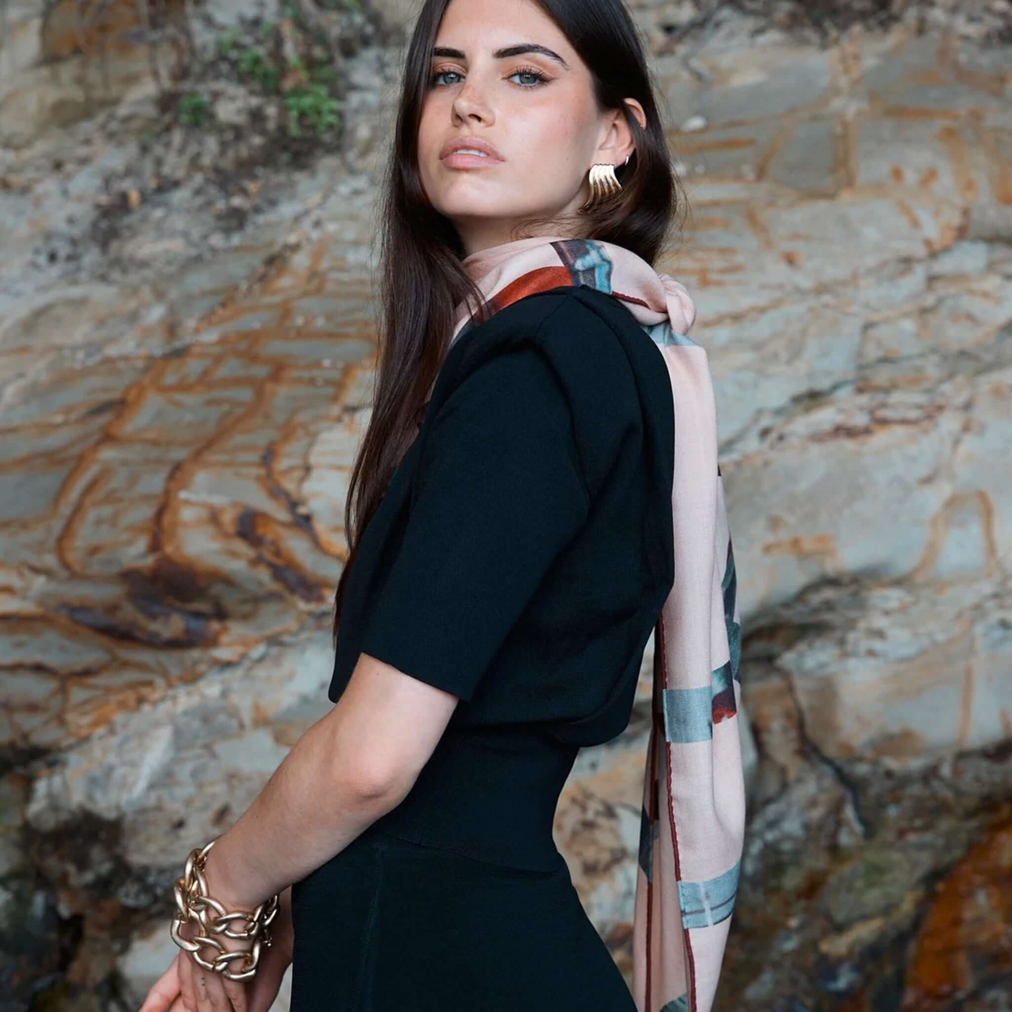 Alt Tag: Good & Co Heritage Triangle Wool & Silk Scarf - Blush worn by model, blush triangle scarf with heritage logo print and contrast hem