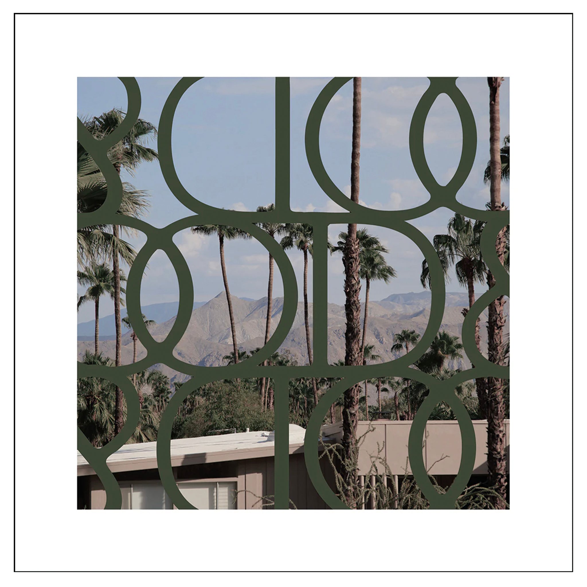 Decorative metal screen with palm trees and mountains in the background