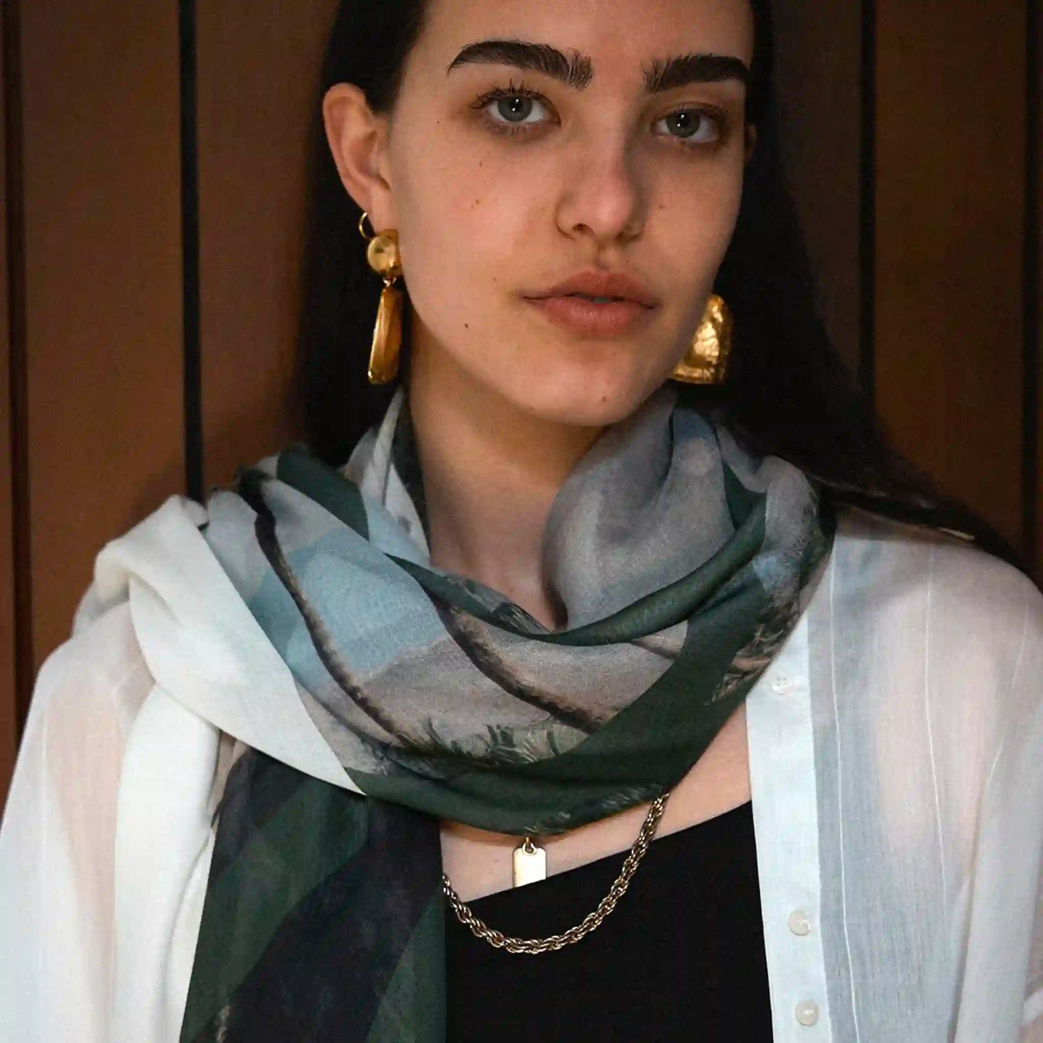 Woman wearing a green scarf with a blurred background