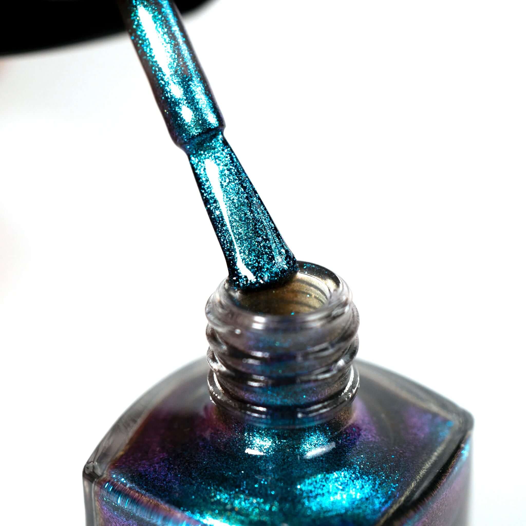 Alt Tag: Hanami Plant Based Nail Polish - Phenomena brush applying shimmering blue-green vegan 21-free plant-based nail polish