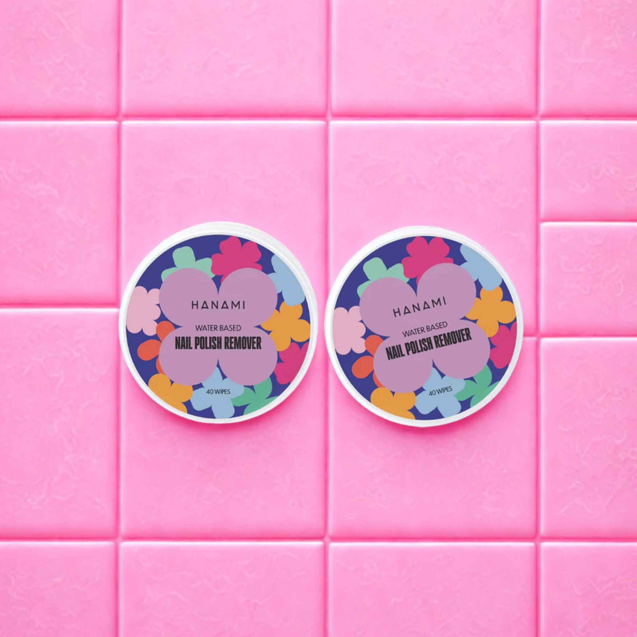 Hanami Water-Based Unscented Nail Polish Remover Wipes tubs on pink tiled background, gentle acetone-free nail polish remover wipes