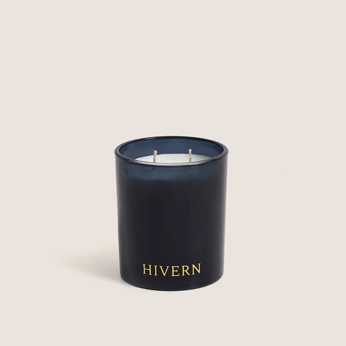 Hivern soy candle lit on a bedside table