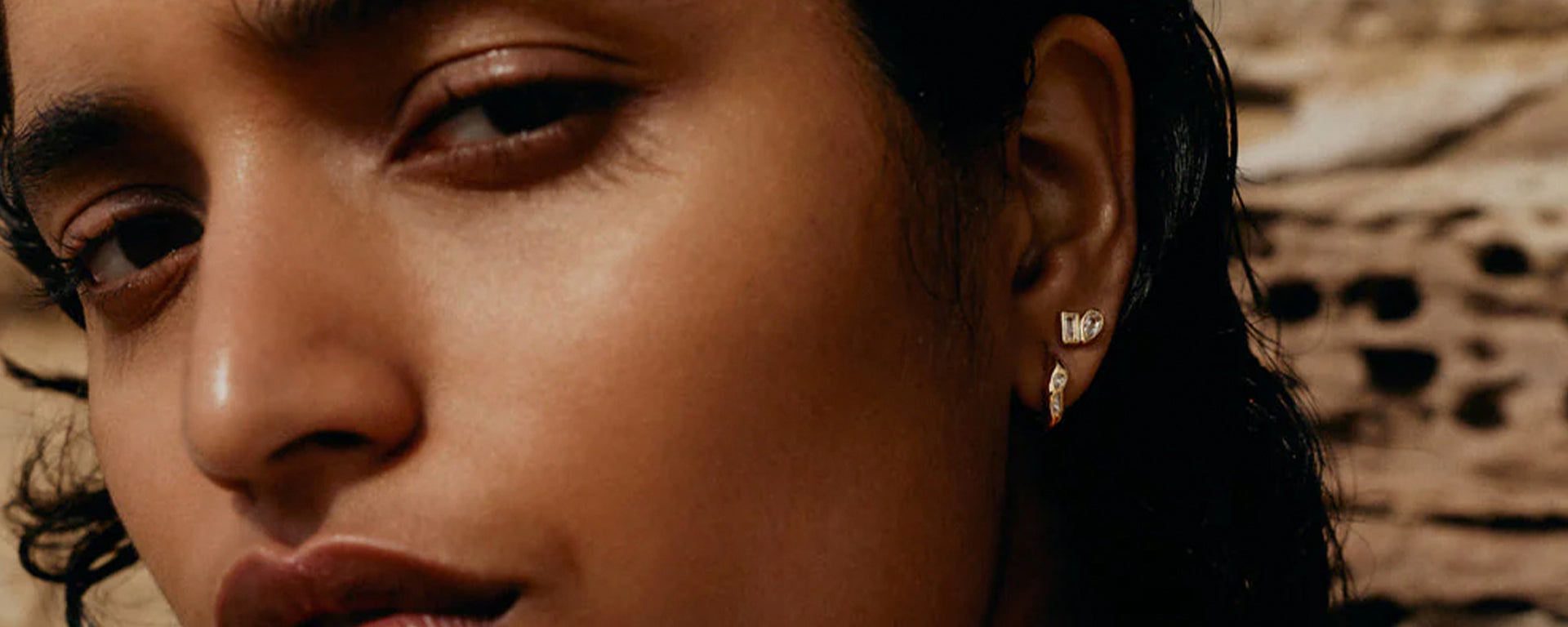 Close-up of a person wearing earrings with a blurred background