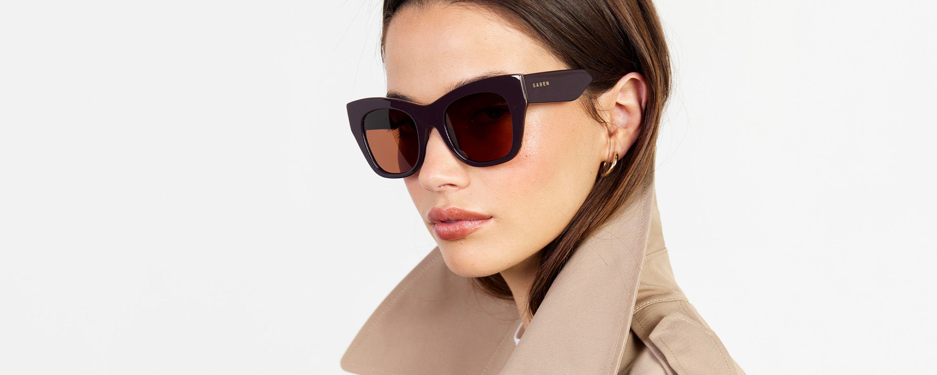 Woman wearing sunglasses with a neutral background