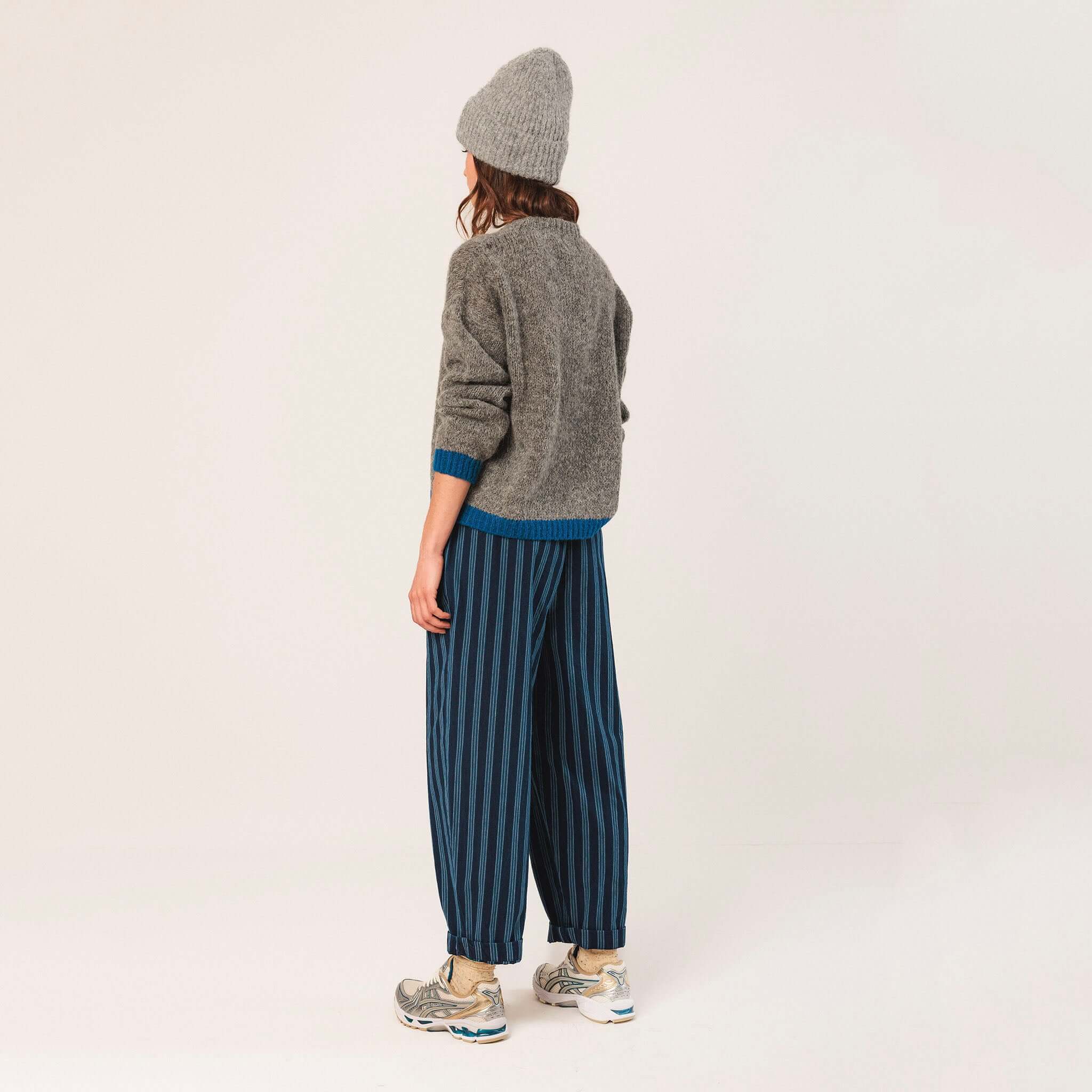Alt Tag: Indi & Cold Alpaca Blend Jersey - Marengo back view relaxed grey knit with bright cuff hem detail styled with striped trousers