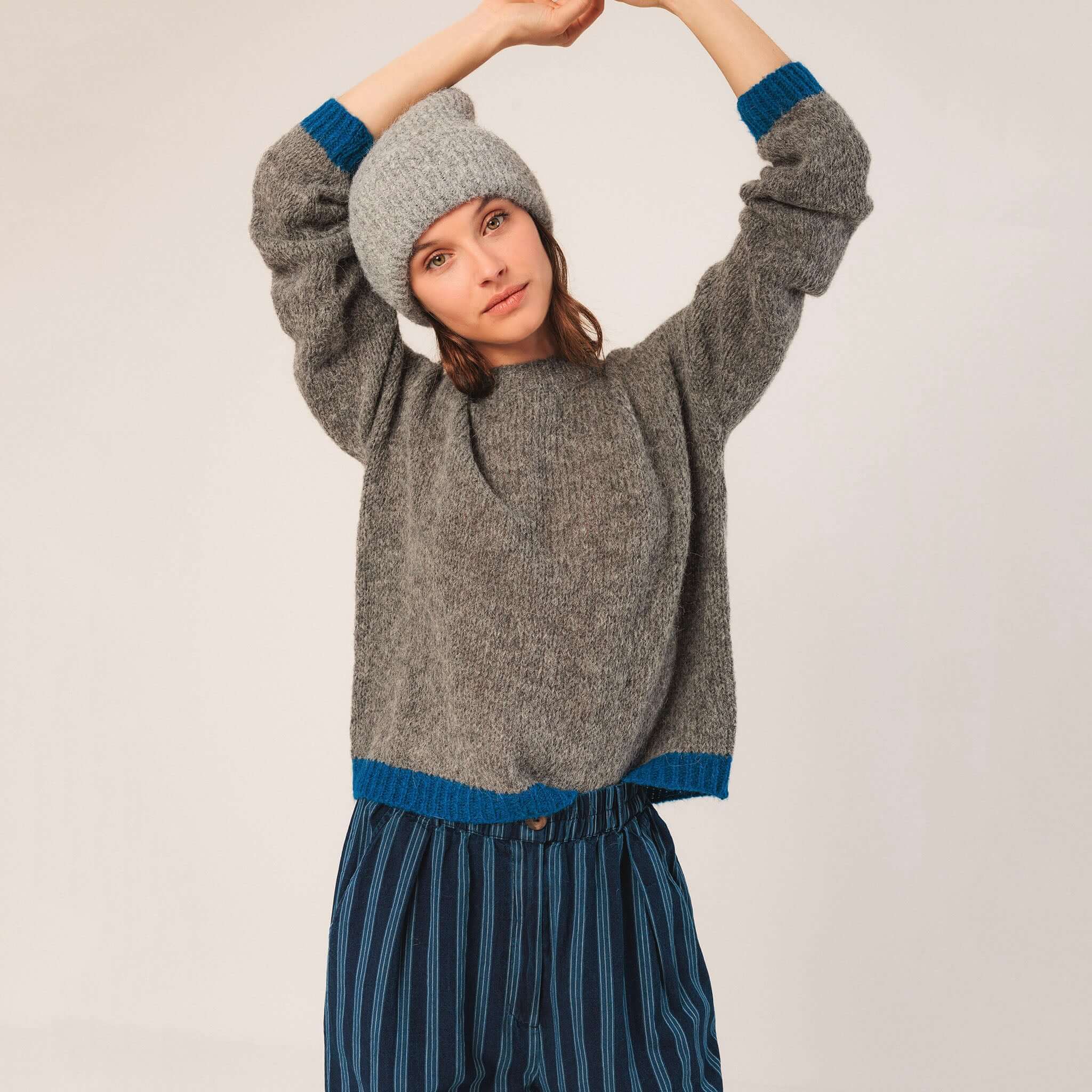 Alt Tag: Indi & Cold Alpaca Blend Jersey - Marengo relaxed grey knit sweater with bright blue cuffs and hem, dropped shoulders