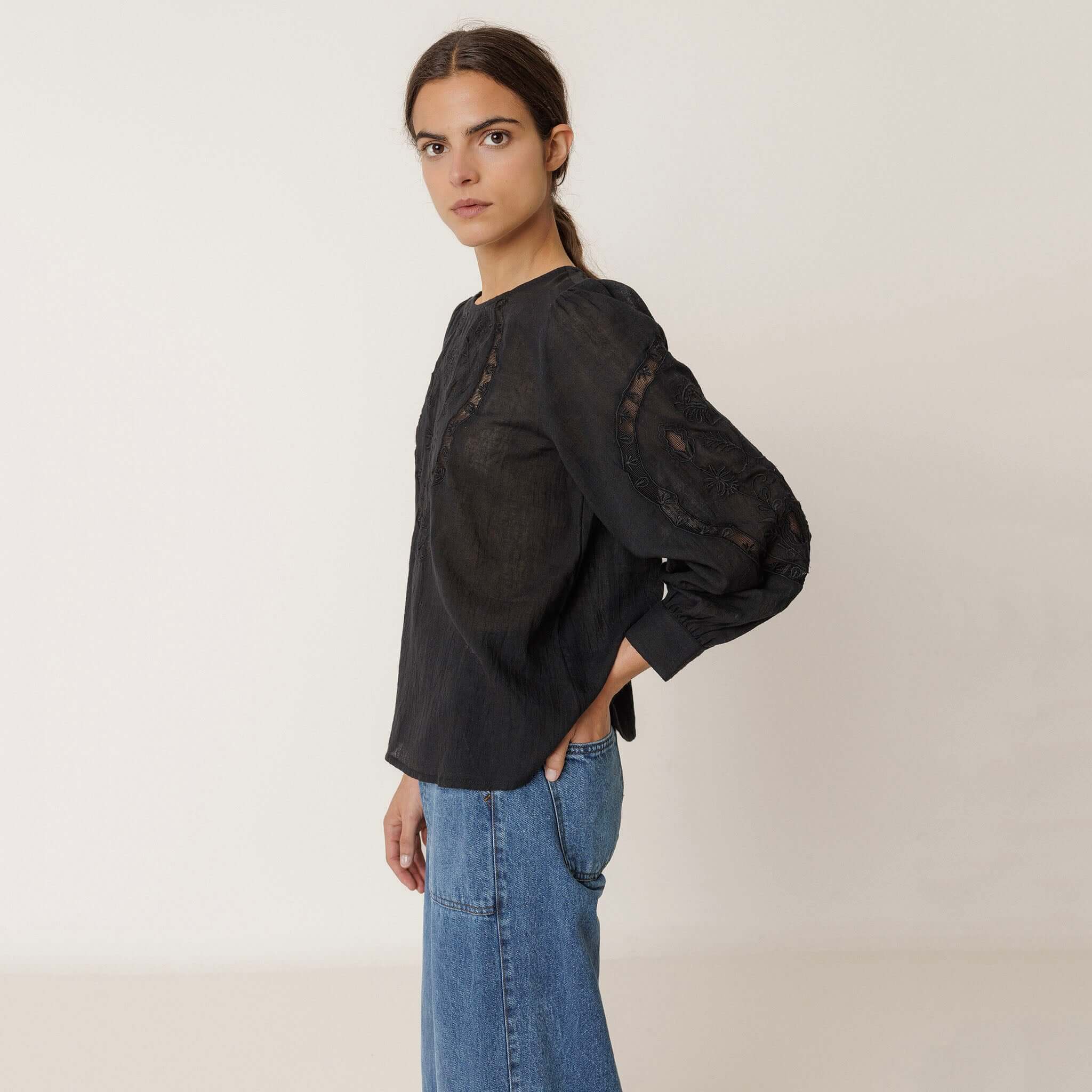 Alt Tag: Indi & Cold Organic Cotton Romantic Embroidered Blouse - Black on model, black embroidered 3/4 sleeve organic cotton gauze top