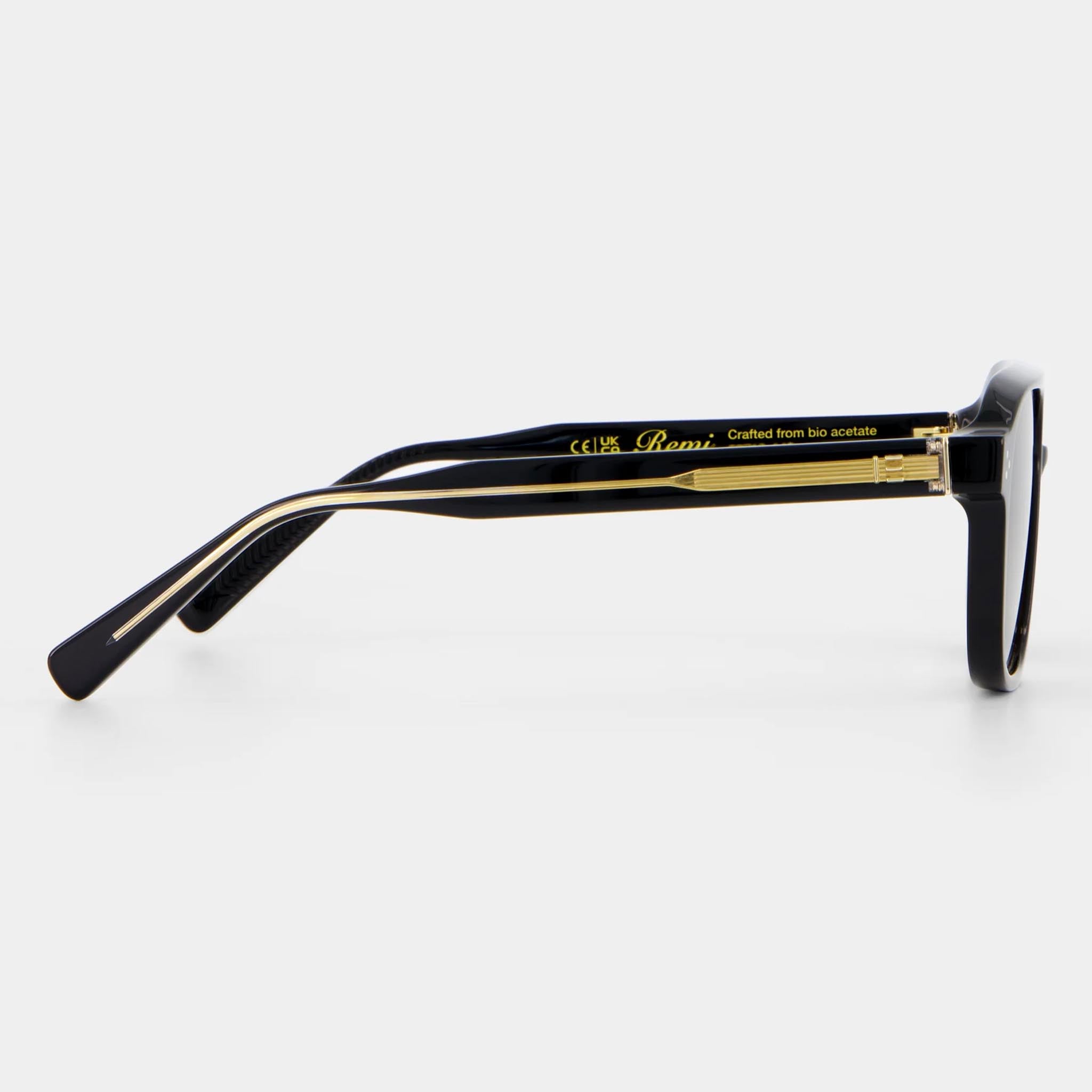 Black sunglasses with gold accents on a white background