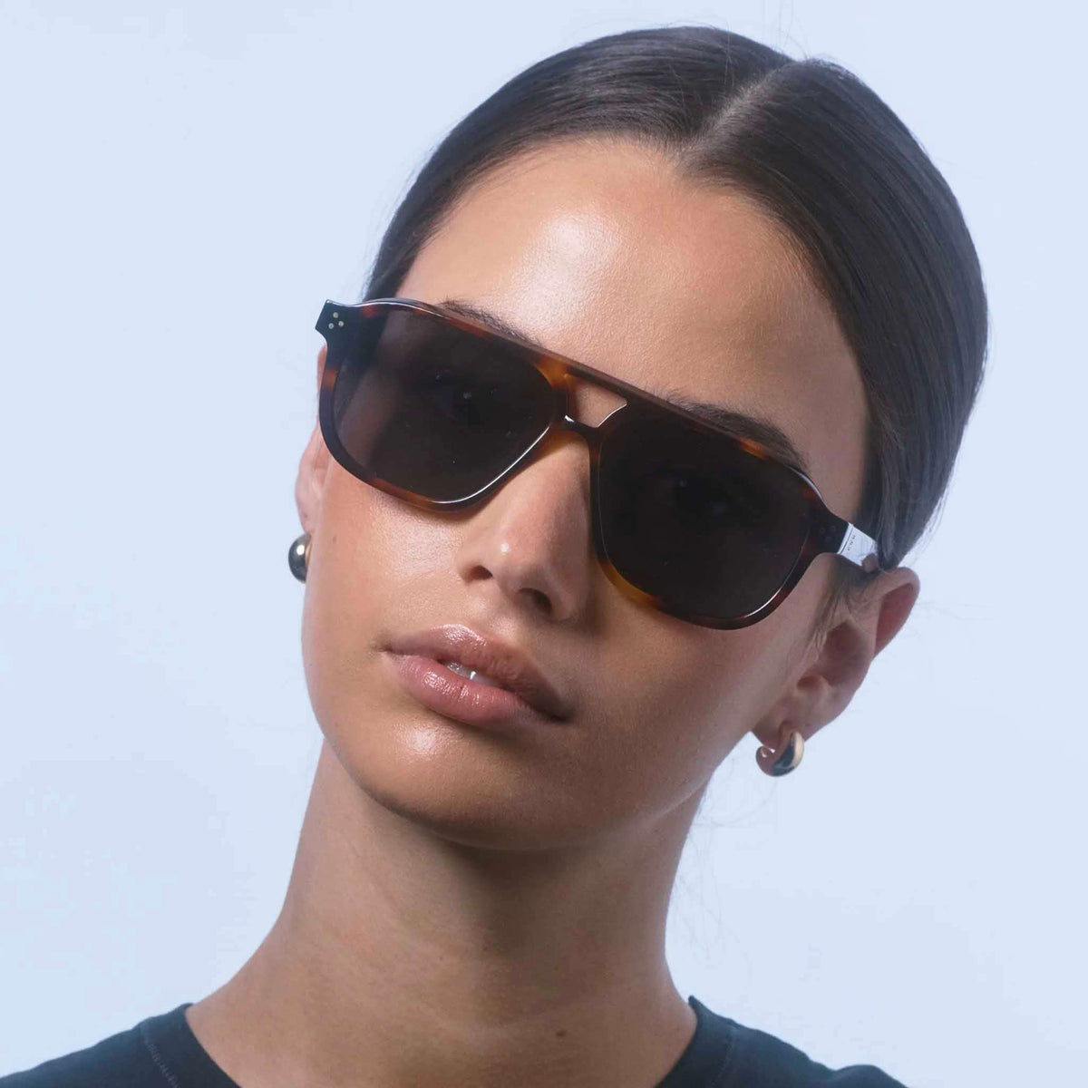 Isle of Eden Sunglasses - Remi Tortoise worn by a model with a confident expression.