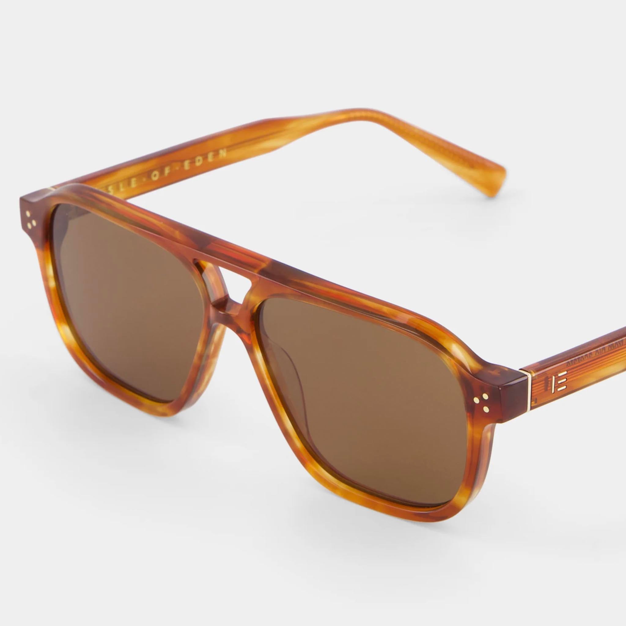 Sunglasses with brown tortoiseshell frame and lenses on a white background