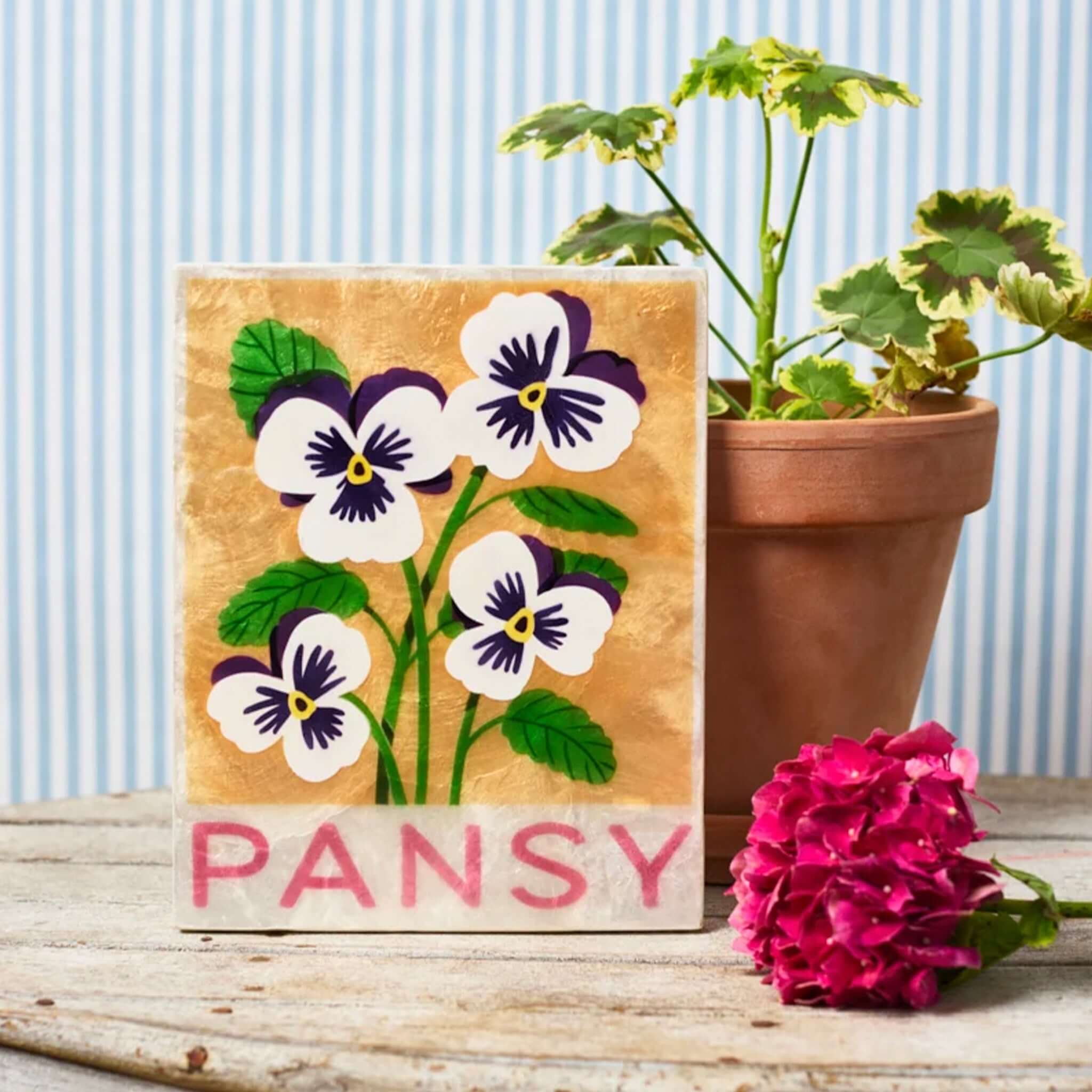 Jones & Co Capiz Shell Market Wall Art - Pansy featuring hand-painted pansy flowers on a golden background.