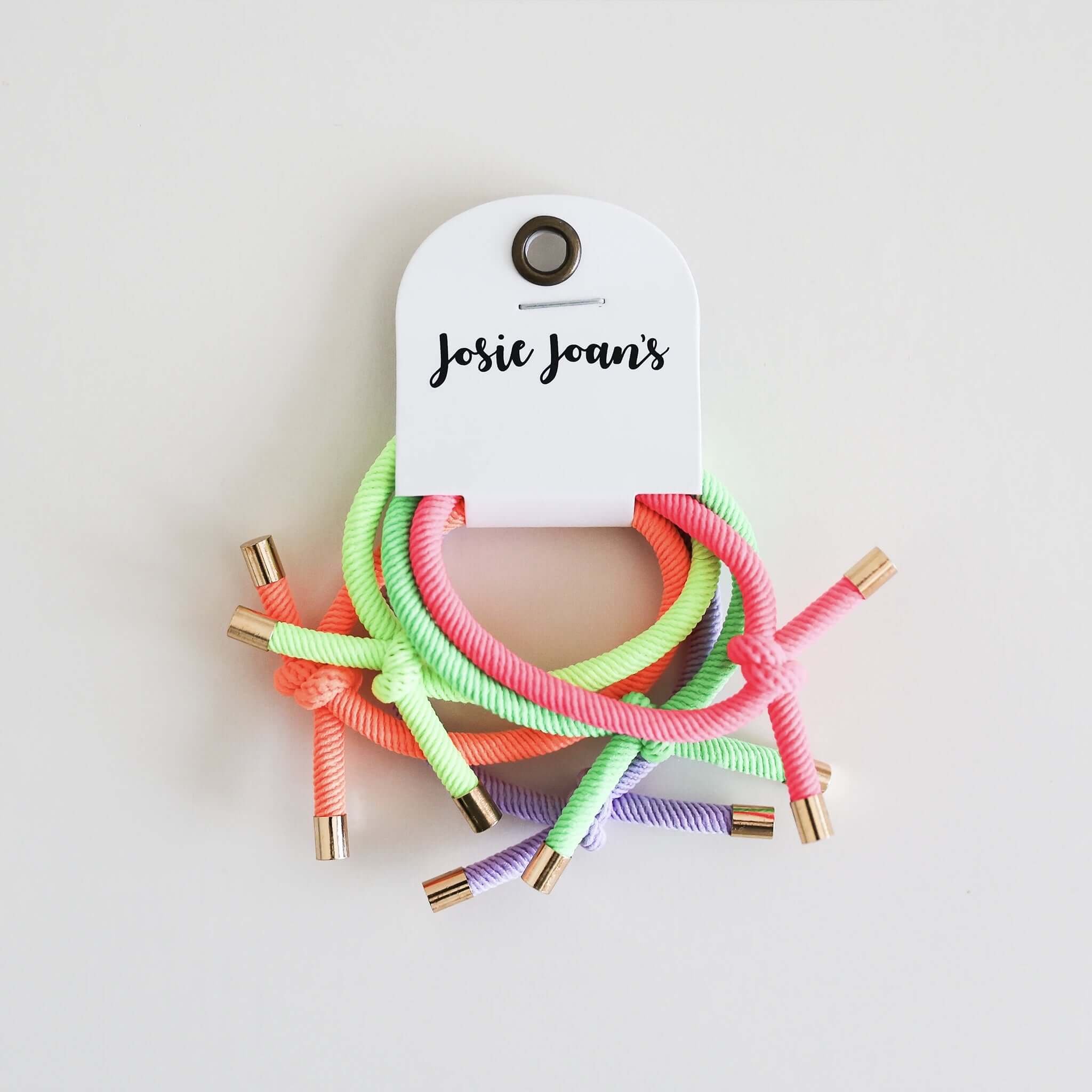 Alt Tag: Josie Joan's Hair Tie Set - Nora on card, five colourful knotted hair ties with gold tips for girls ponytails