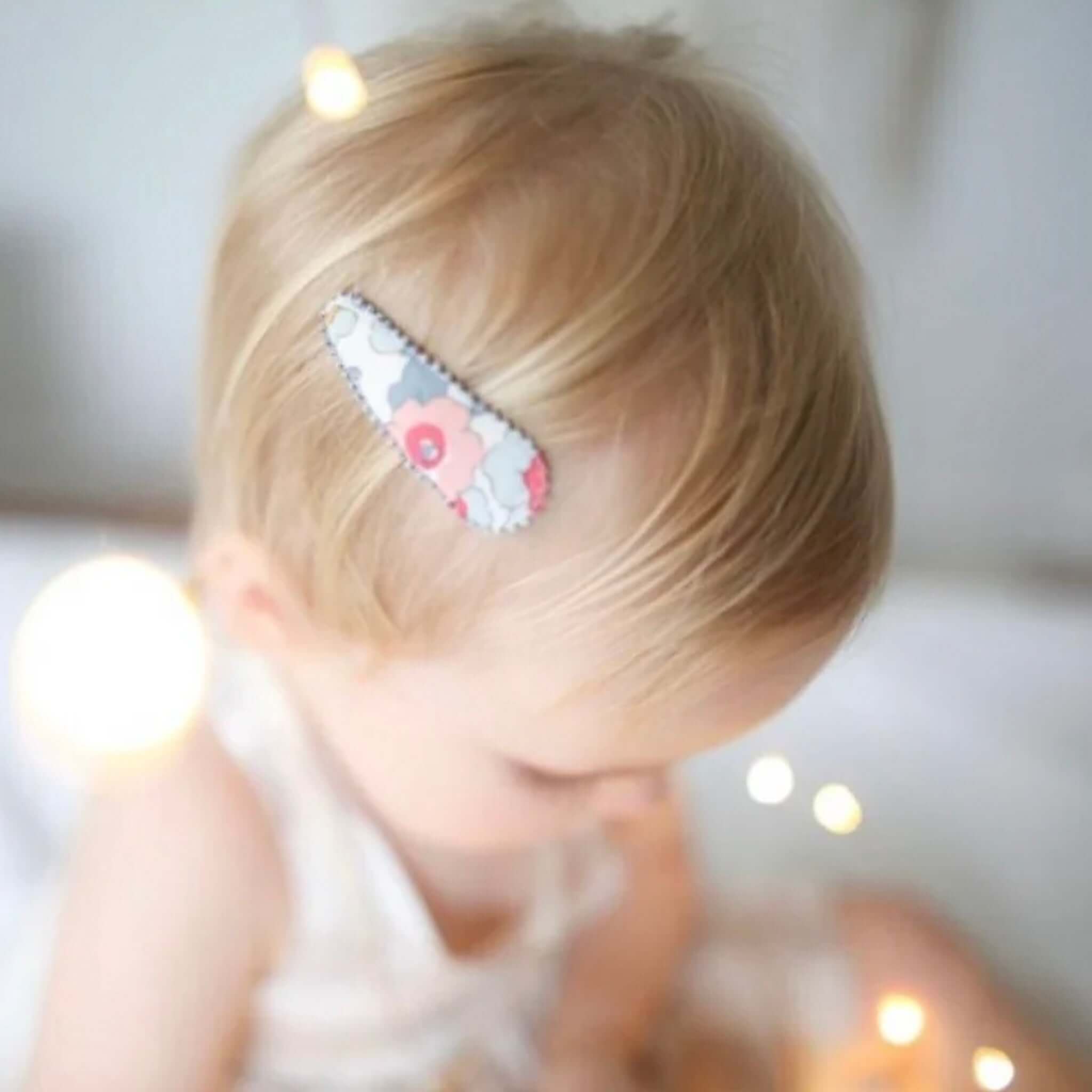 Alt Tag: Josie Joan's Hair Clip Set - Izzy fabric-covered snap clip with scalloped edge Liberty London floral print on toddler hair