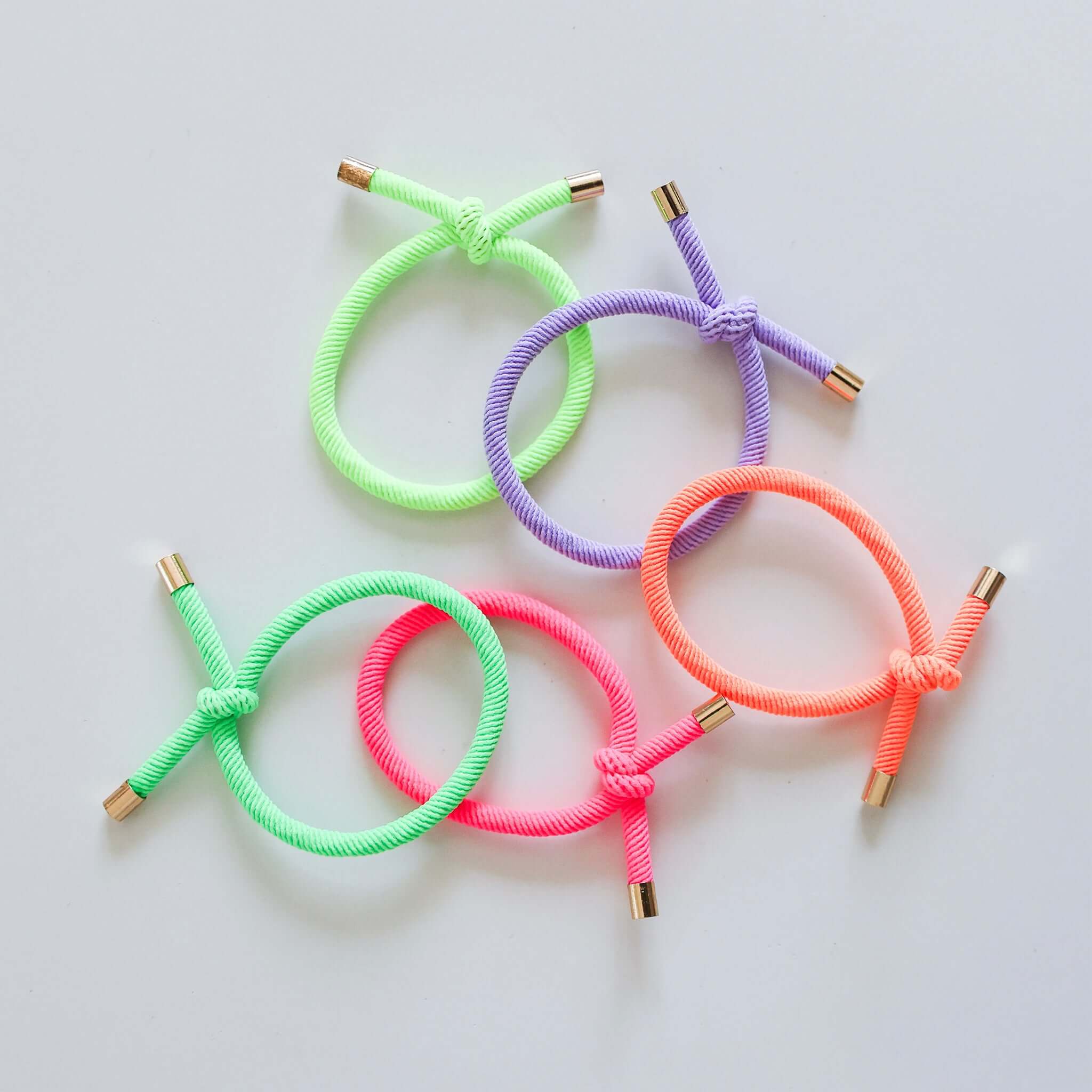 Alt Tag: Josie Joan's Hair Tie Set - Nora five knotted kids hair ties in neon colours with gold tips
