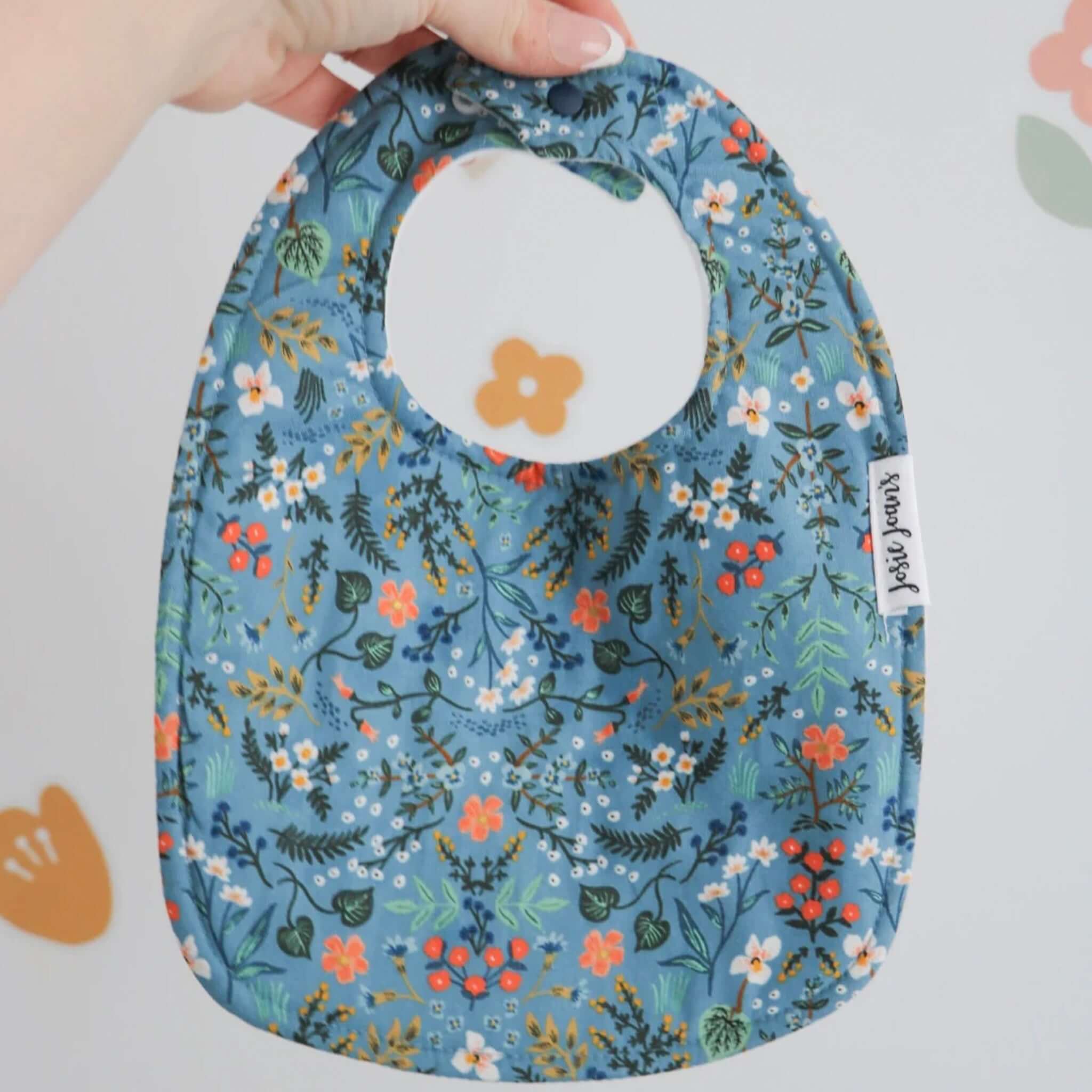 Alt Tag: Josie Joan's Linen Bib - Bethany blue floral Rifle Paper Co baby bib with snap buttons and micro fleece backing