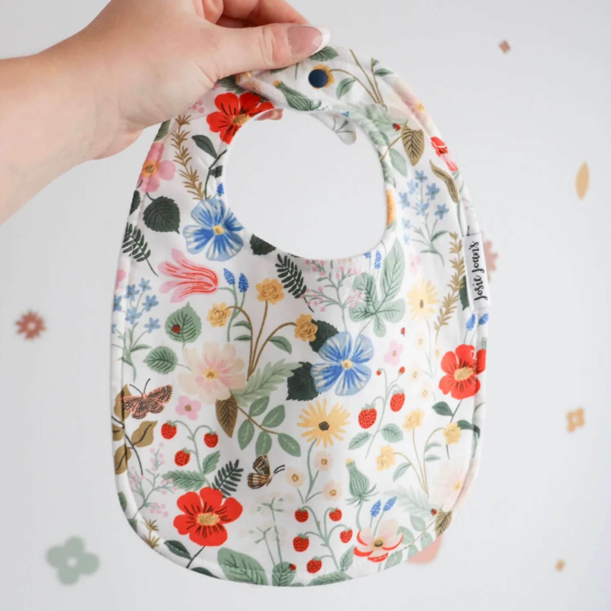 Alt Tag: Josie Joan's Linen Bib - Sybil floral Rifle Paper Co linen baby bib with snap buttons and micro fleece backing