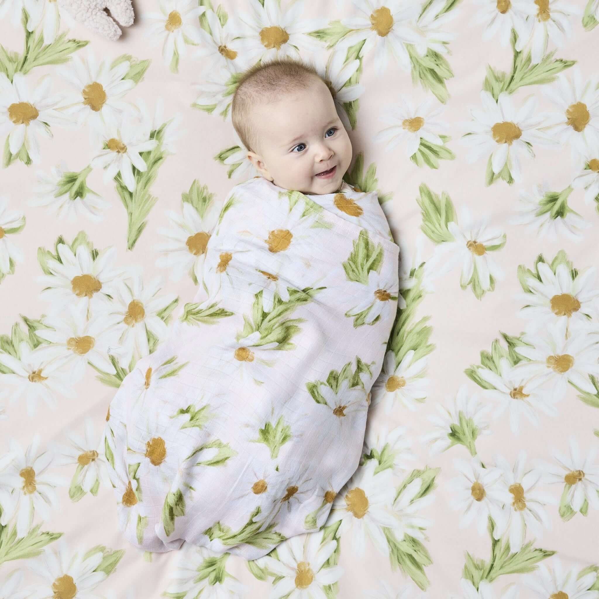 Alt Tag: Kip & Co Bambo Swaddle - Sweet Daisy baby wrapped in soft bamboo swaddle with pastel daisy floral print, breathable and gentle