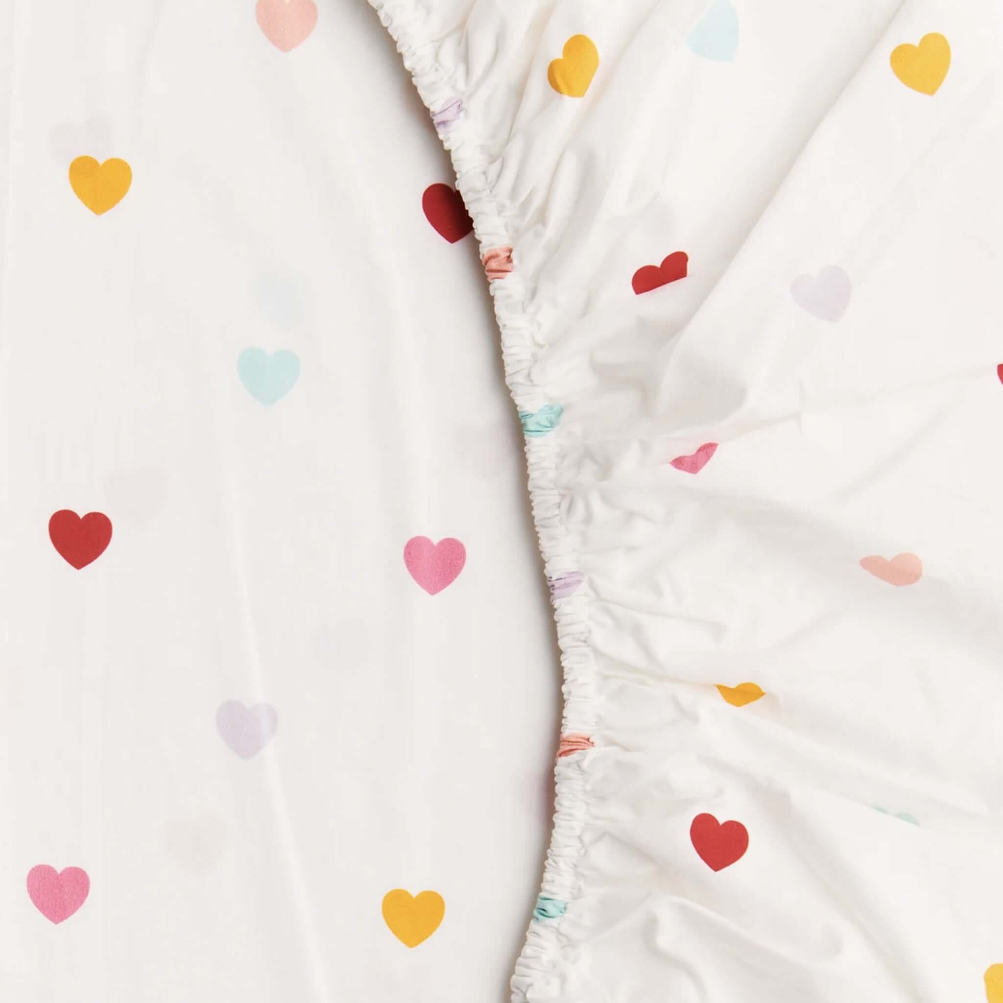Alt Tag: Kip & Co Organic  Cotton Baby Fitted Cot Sheet - I Heart You with multicolour heart print on white organic cotton fitted sheet