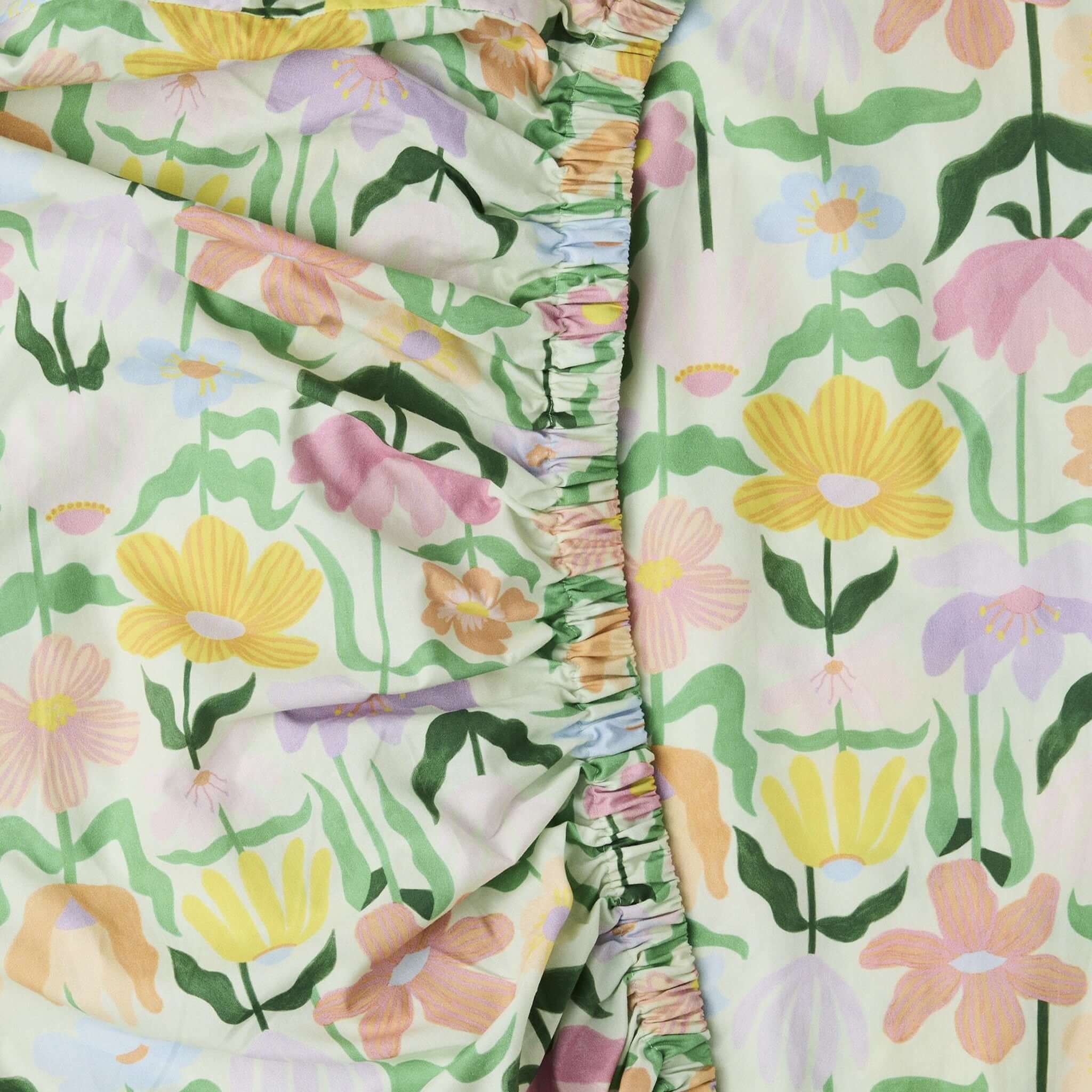 Alt Tag: Kip & Co Organic Cotton Baby Fitted Cot Sheet - Popping Flowers Green pastel floral print GOTS organic cotton fitted cot sheet