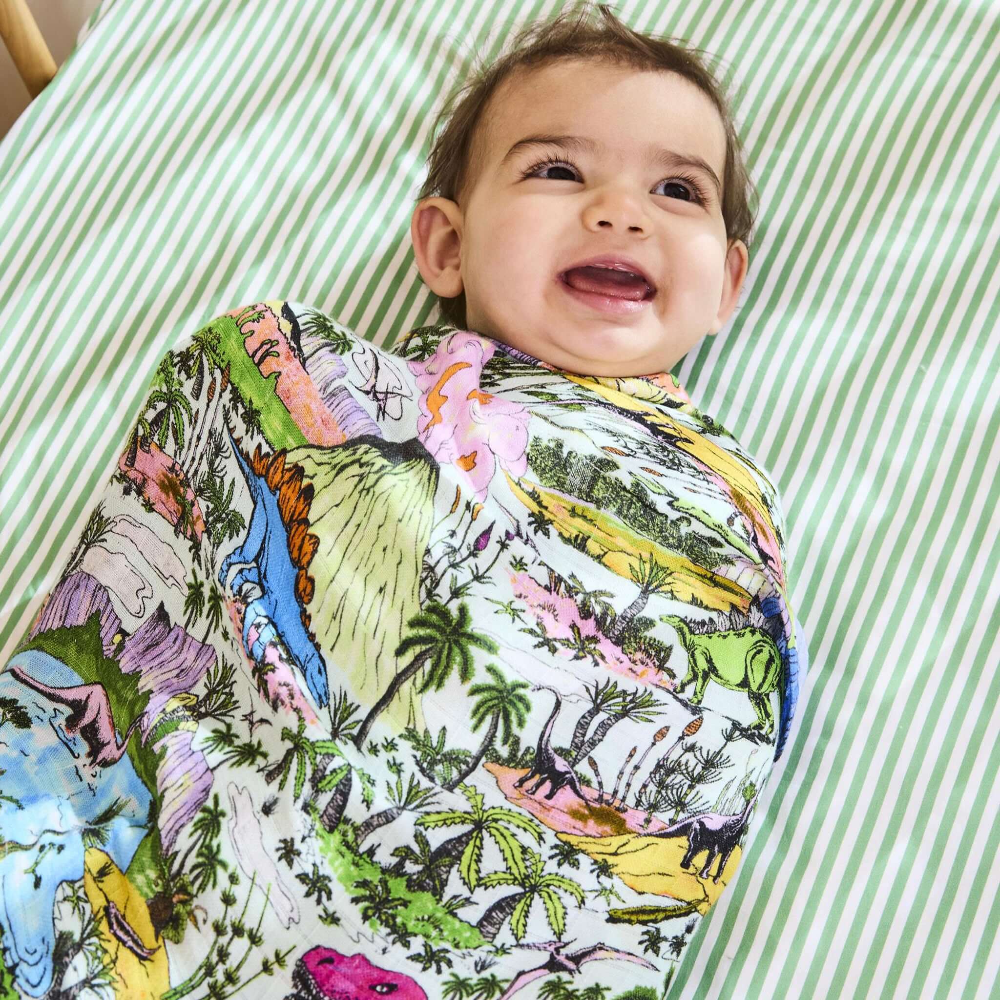Alt Tag: Kip & Co Bambo Swaddle - Jurassic bamboo baby swaddle blanket with colorful dinosaur print, soft breathable wrap for newborn snuggles