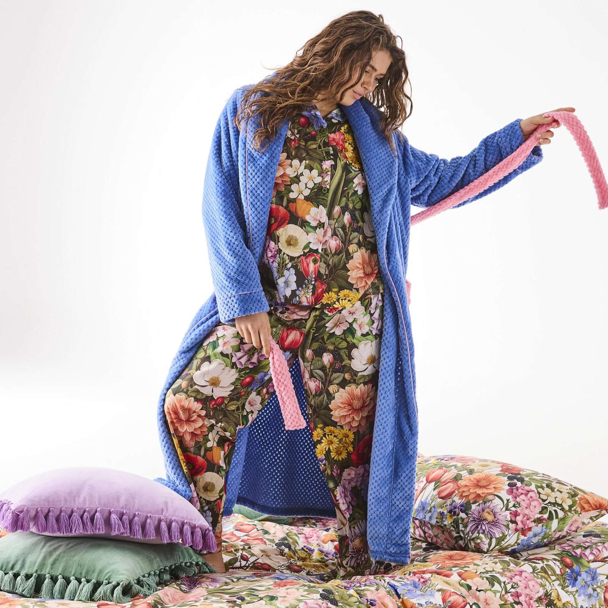 Alt Tag: Kip & Co Cosy Robe - Pie in the Sky quilted French blue robe with pink trim and pockets, worn for cosy relaxation
