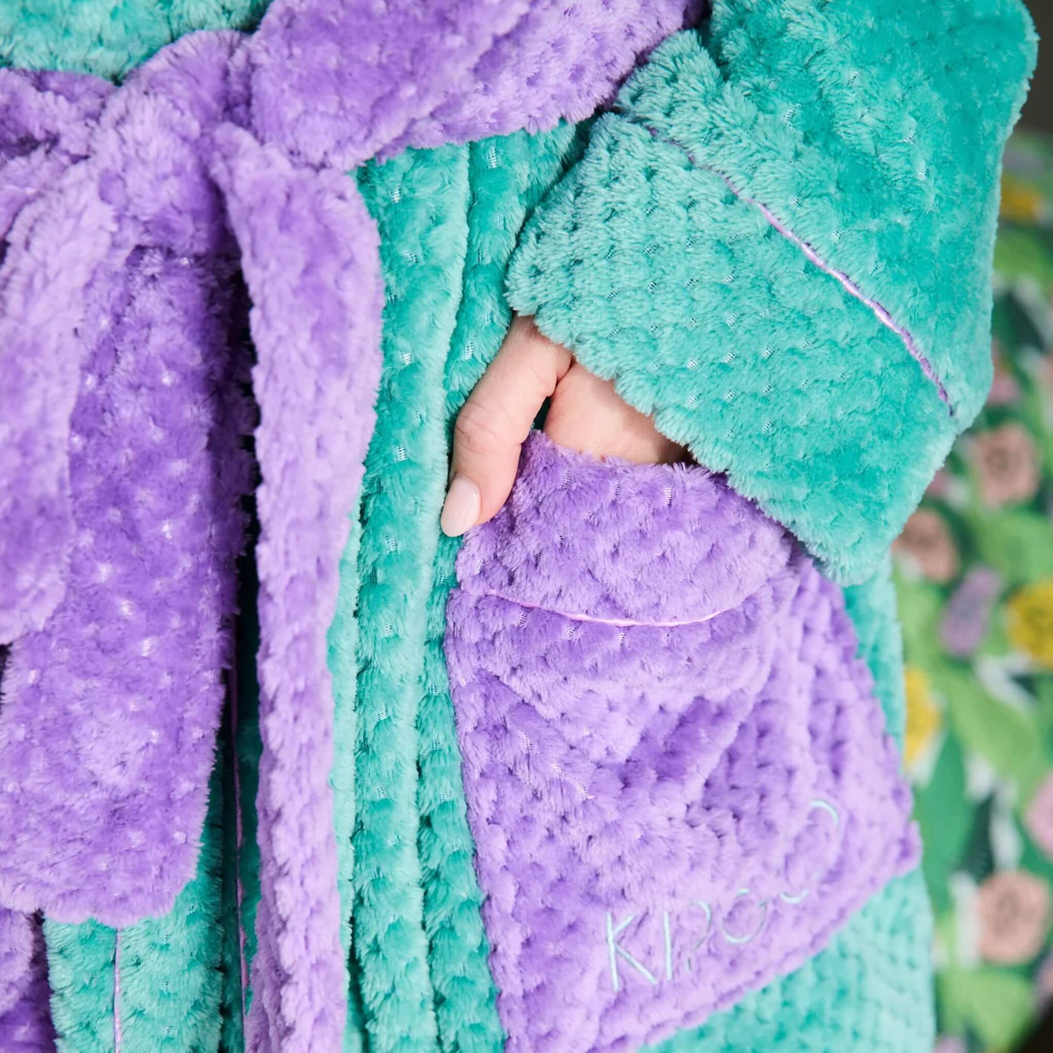 Alt Tag: Kip & Co Cosy Robe - Tropicas close-up of soft teal and purple recycled plush robe with pocket detail