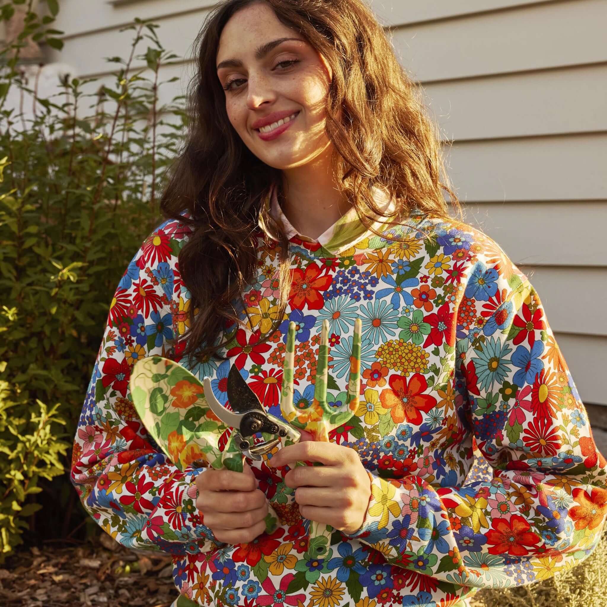 Alt Tag: Kip & Co Garden Tools & Gloves Set - Nasturtium with floral gloves and garden secateurs held outdoors