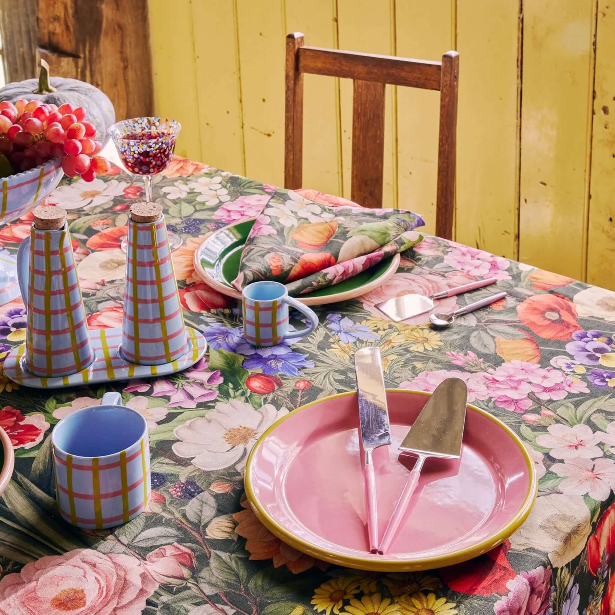 Alt Tag: Kip & Co Linen & Cotton Tablecloth - Cottage Garden Eden floral tablecloth on dining table with colorful plates, cups and cutlery