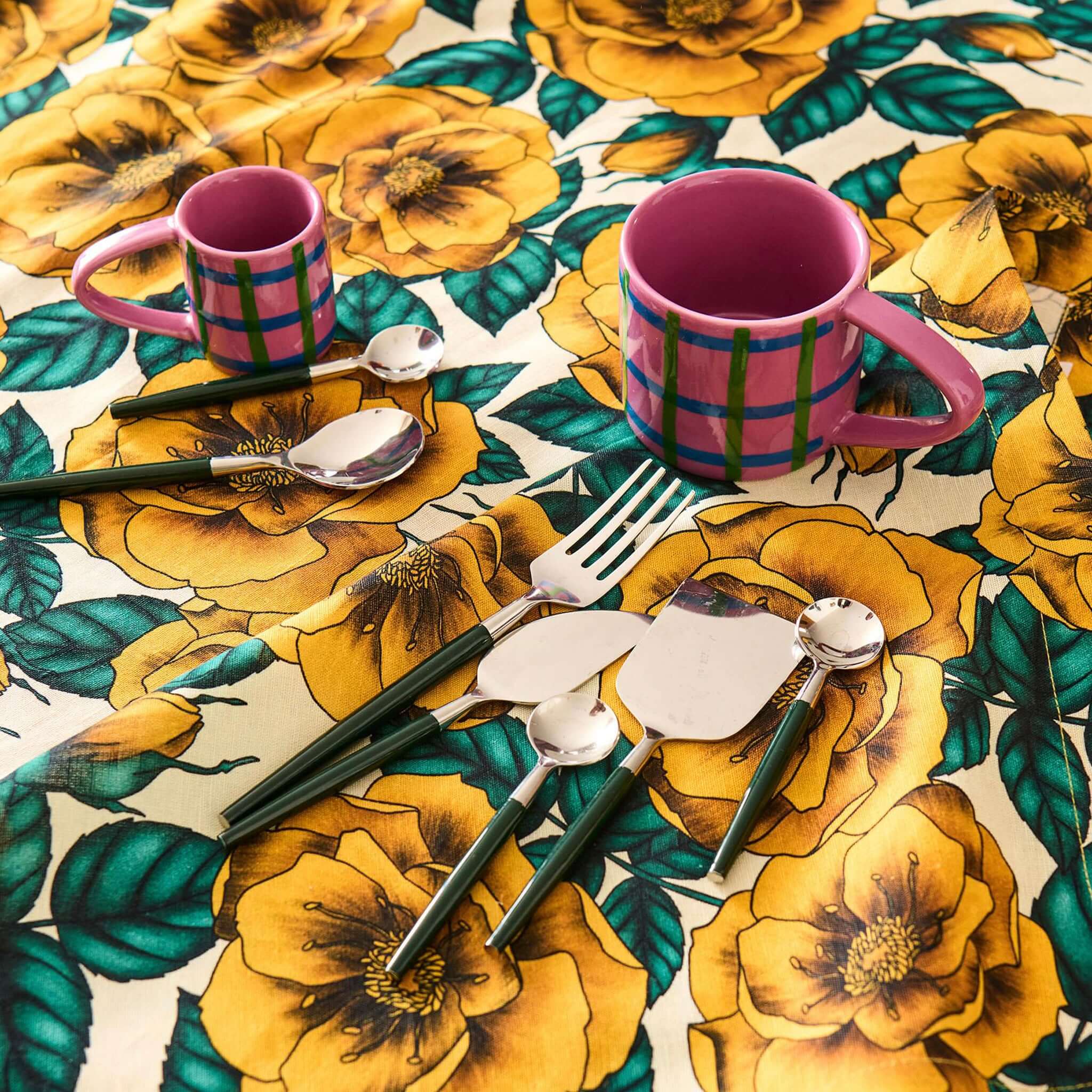 Alt Tag: Kip & Co Linen & Cotton Tablecloth - Golden Peony with golden peony floral print, blue leaves, set table with cutlery and mugs