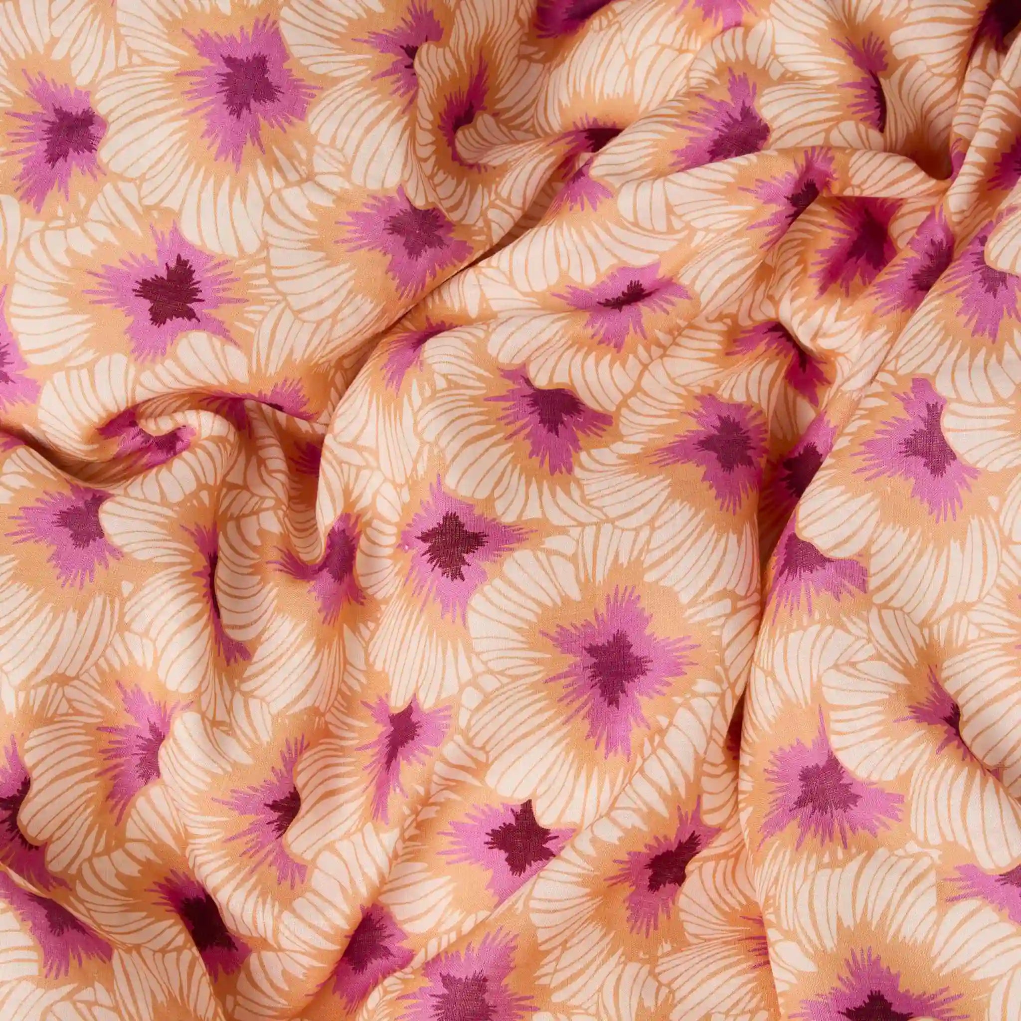 Close-up of fabric with pink floral pattern on beige background