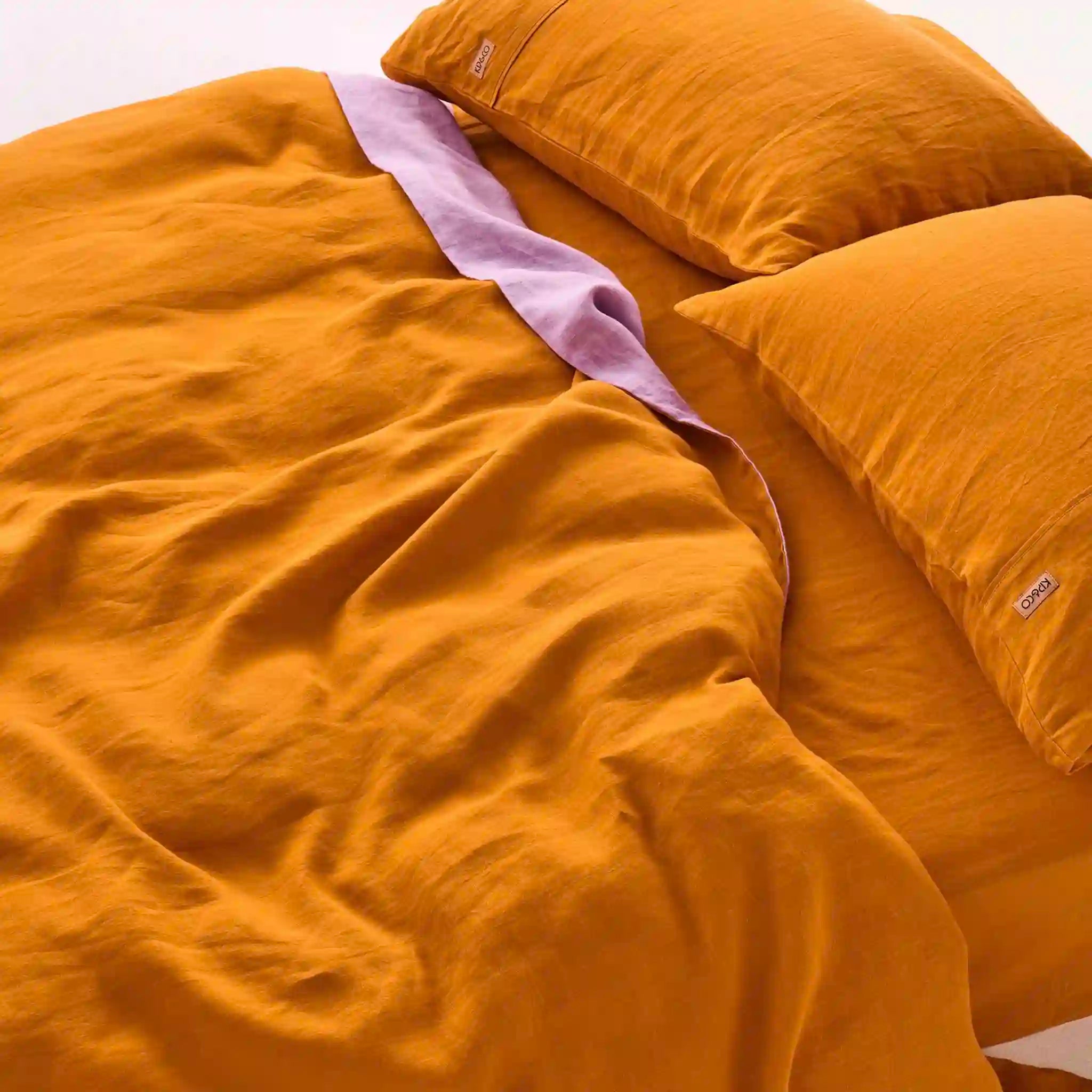 Mustard yellow bedding set with a pillow on a white background
