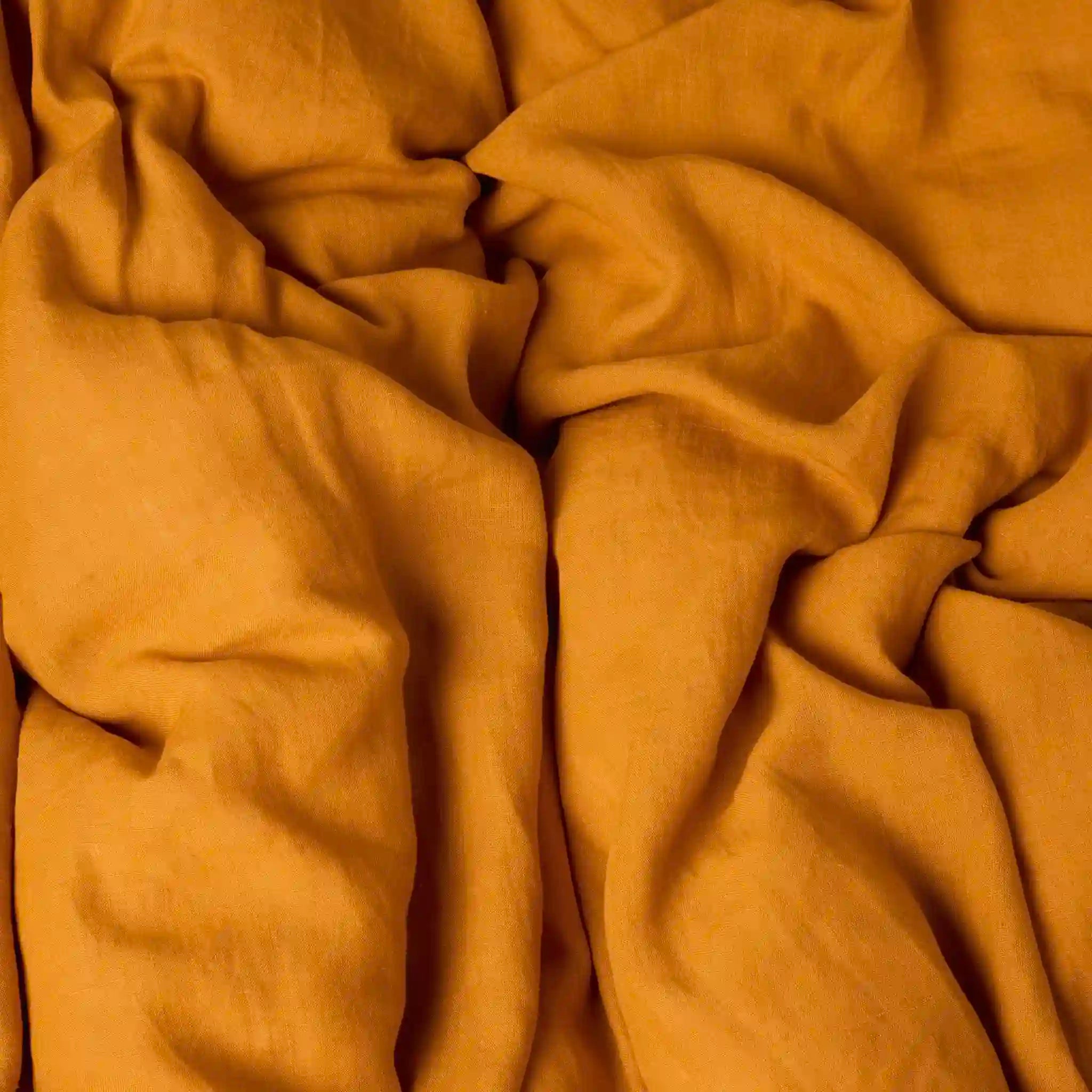 Close-up of textured mustard yellow flat sheet.
