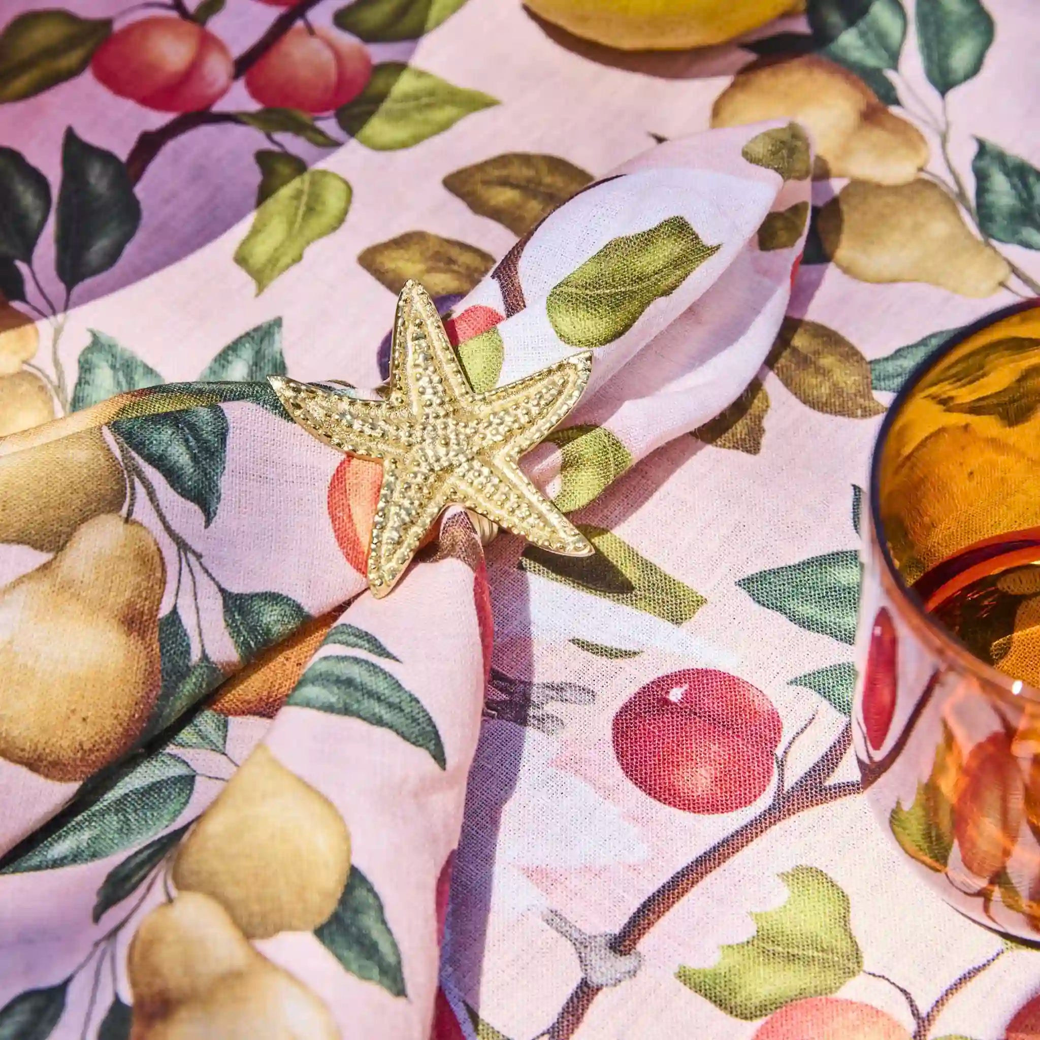 Star-shaped object on a tablecloth with fruit pattern