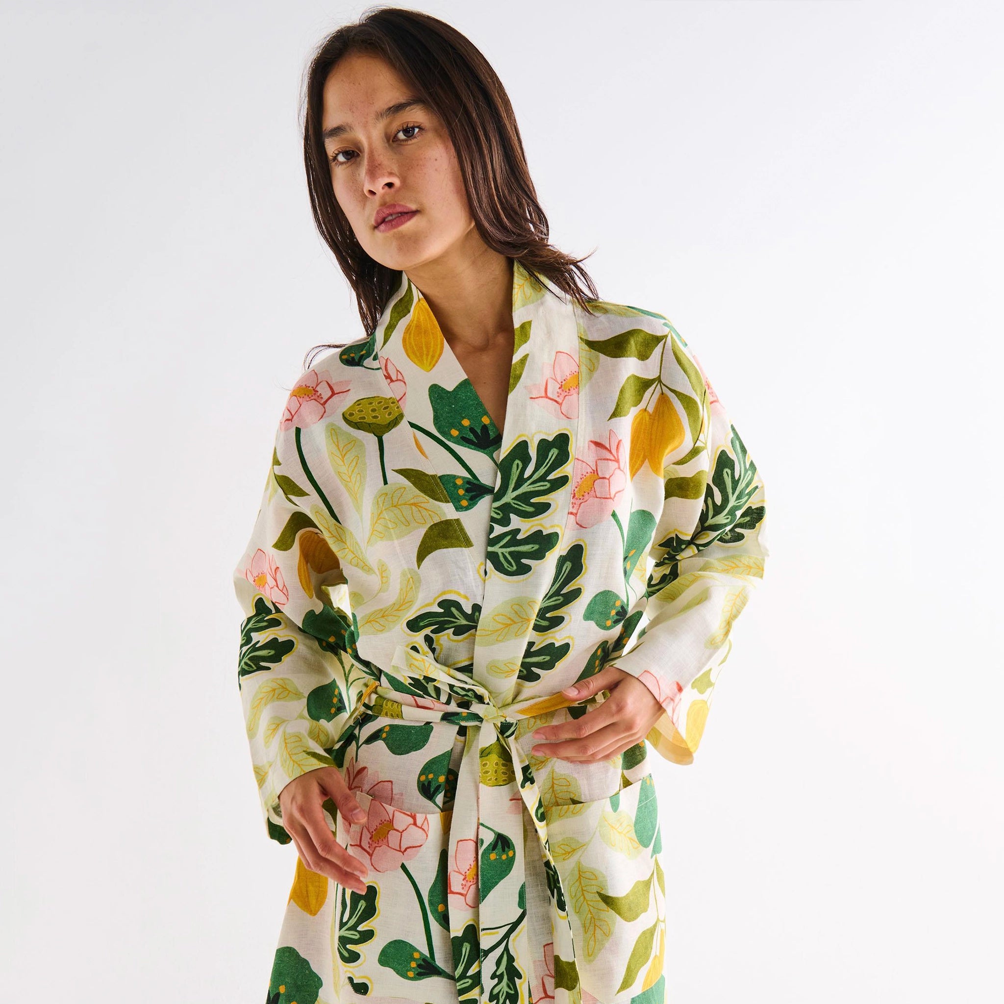 Woman wearing a floral robe on a white background