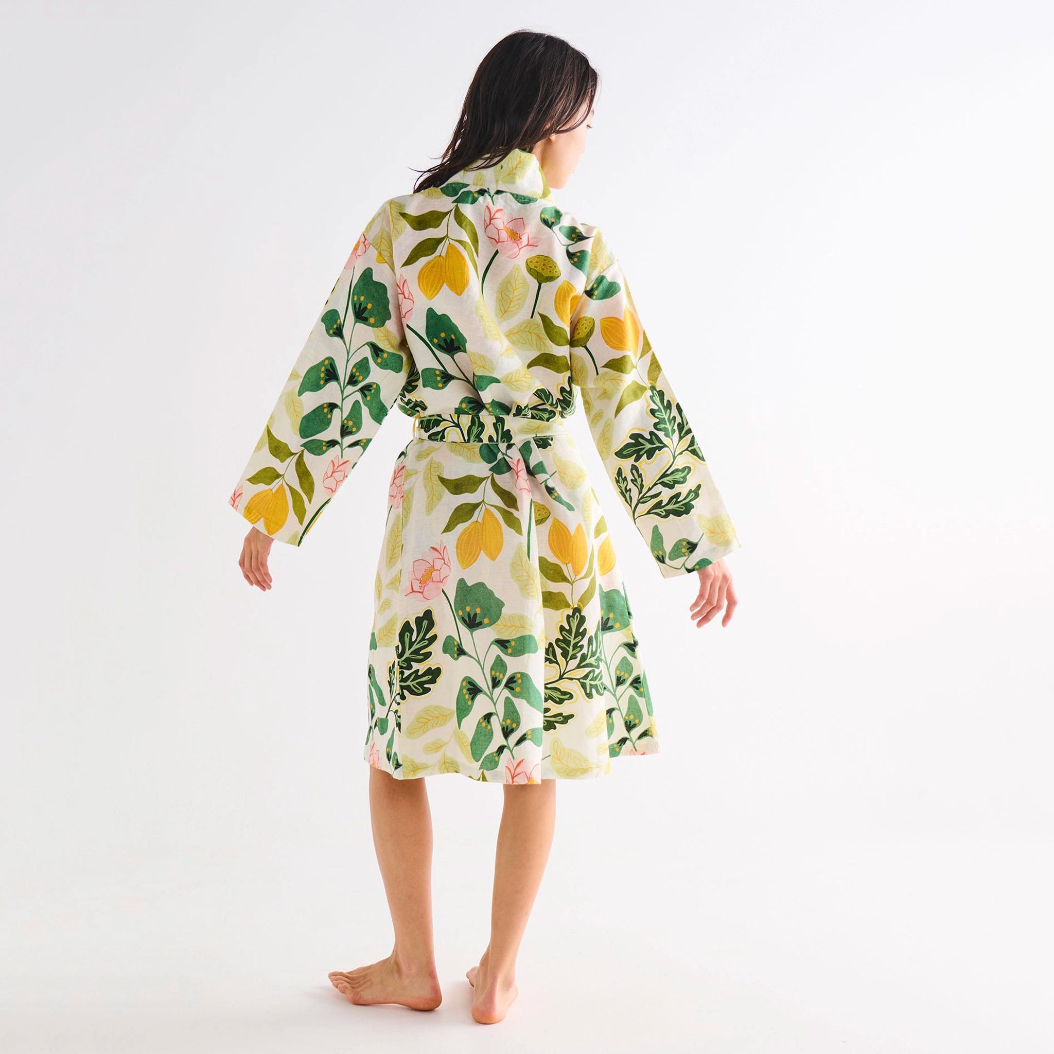 Woman wearing a floral-patterned robe on a white background
