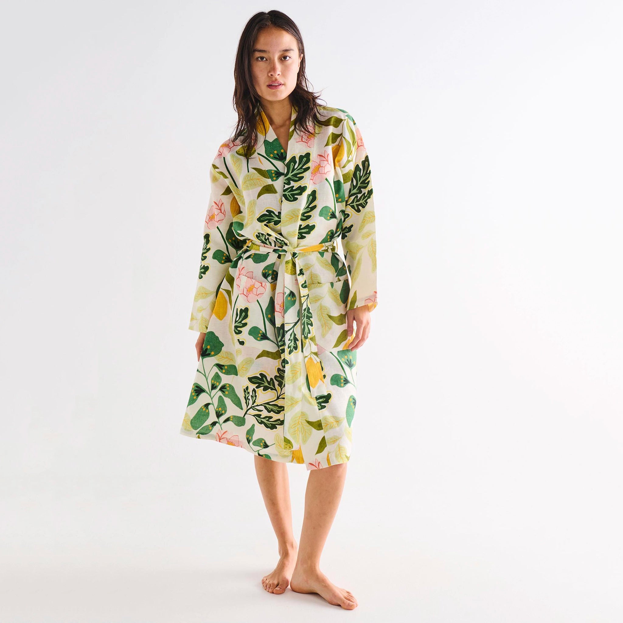 Woman wearing a floral robe on a white background