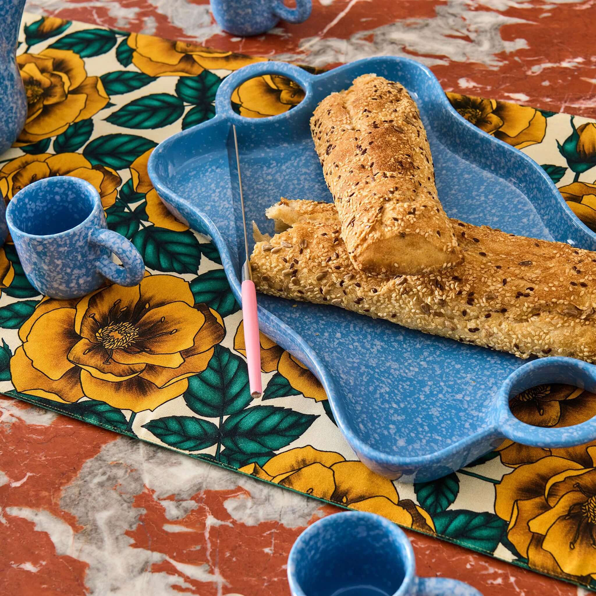Alt Tag: Kip & Co Linen Table Runner - Golden Peony floral linen-cotton table runner with golden peony blooms styled with blue tableware