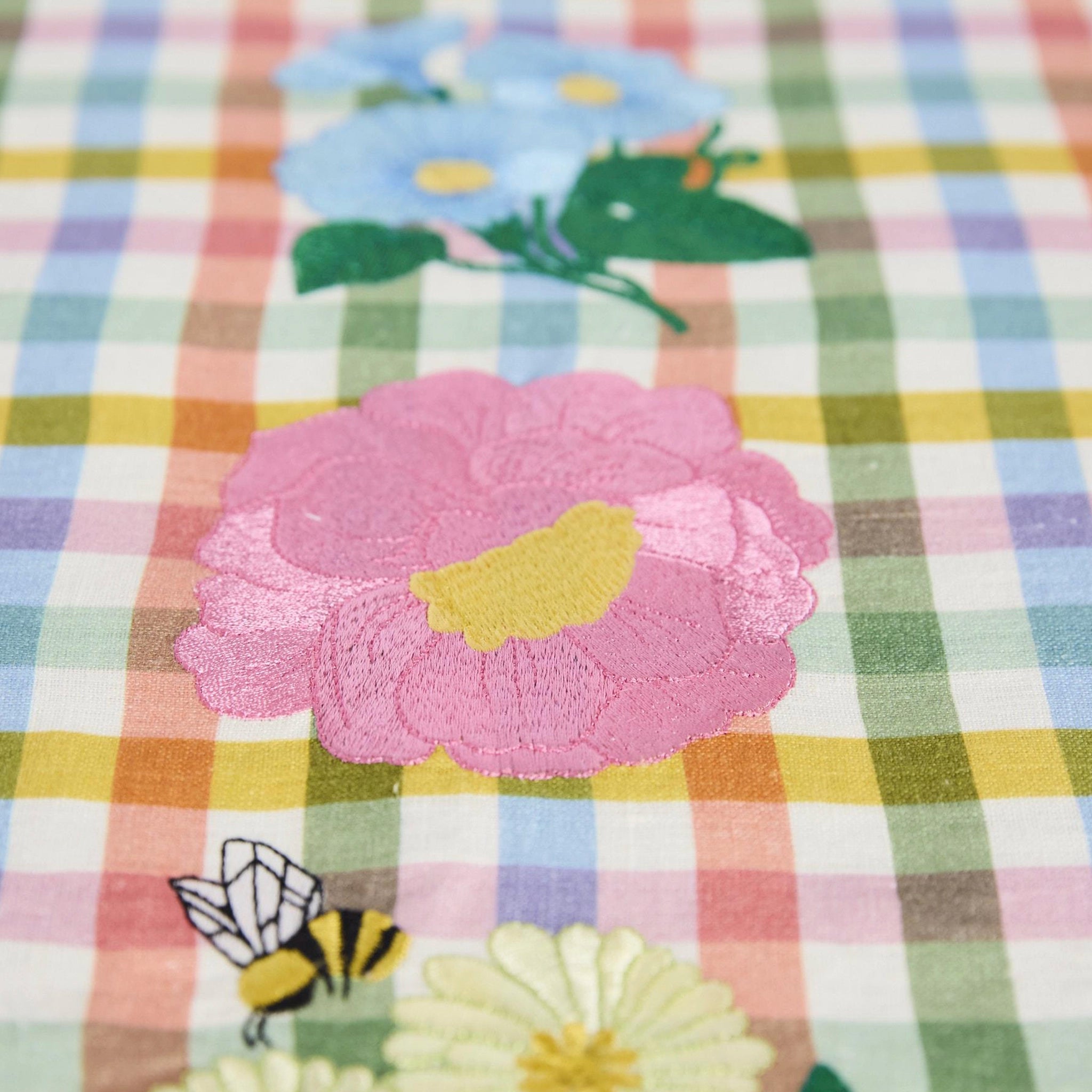 Checkered fabric with floral and bee embroidery