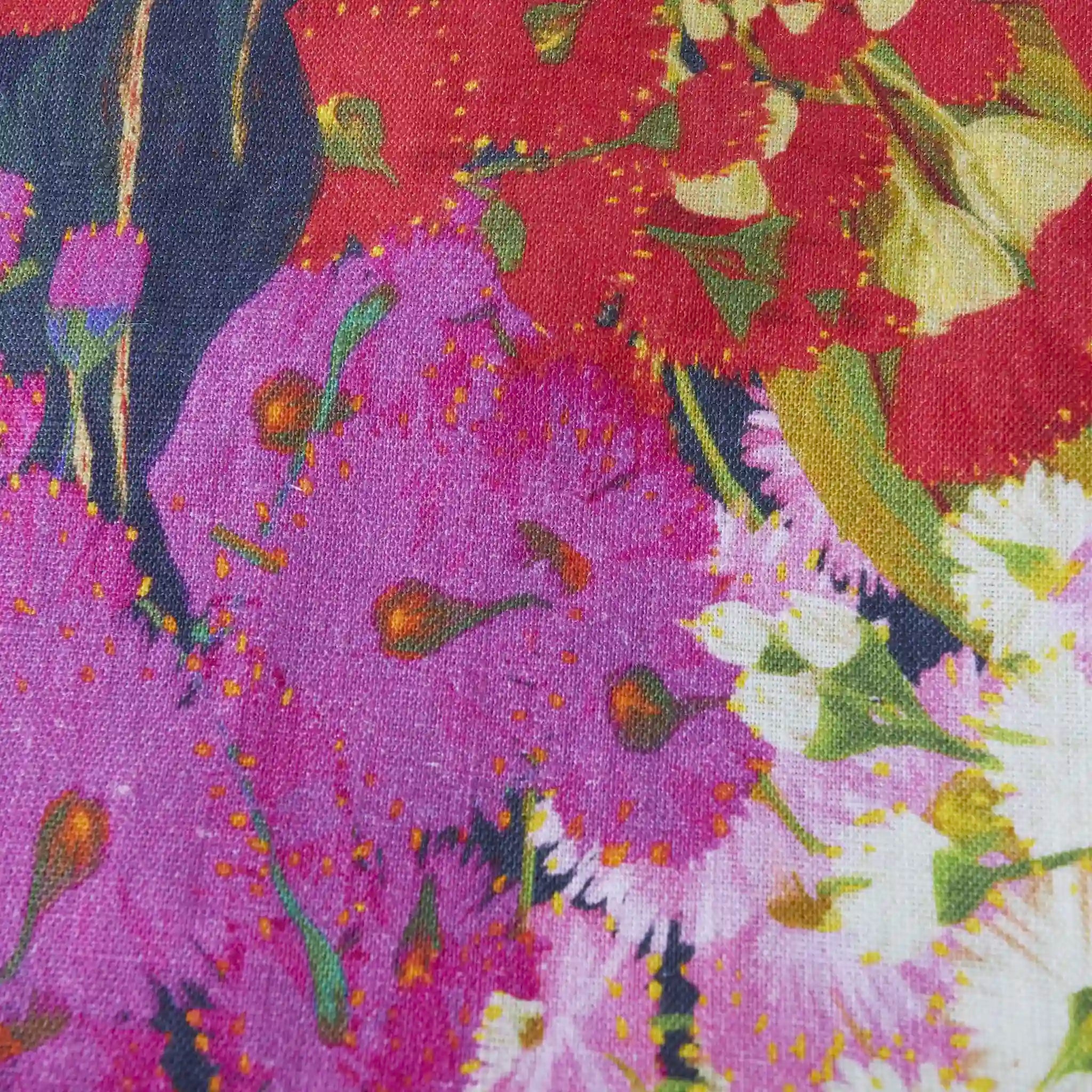 Close-up of a colorful floral pattern with purple, red, and white flowers.